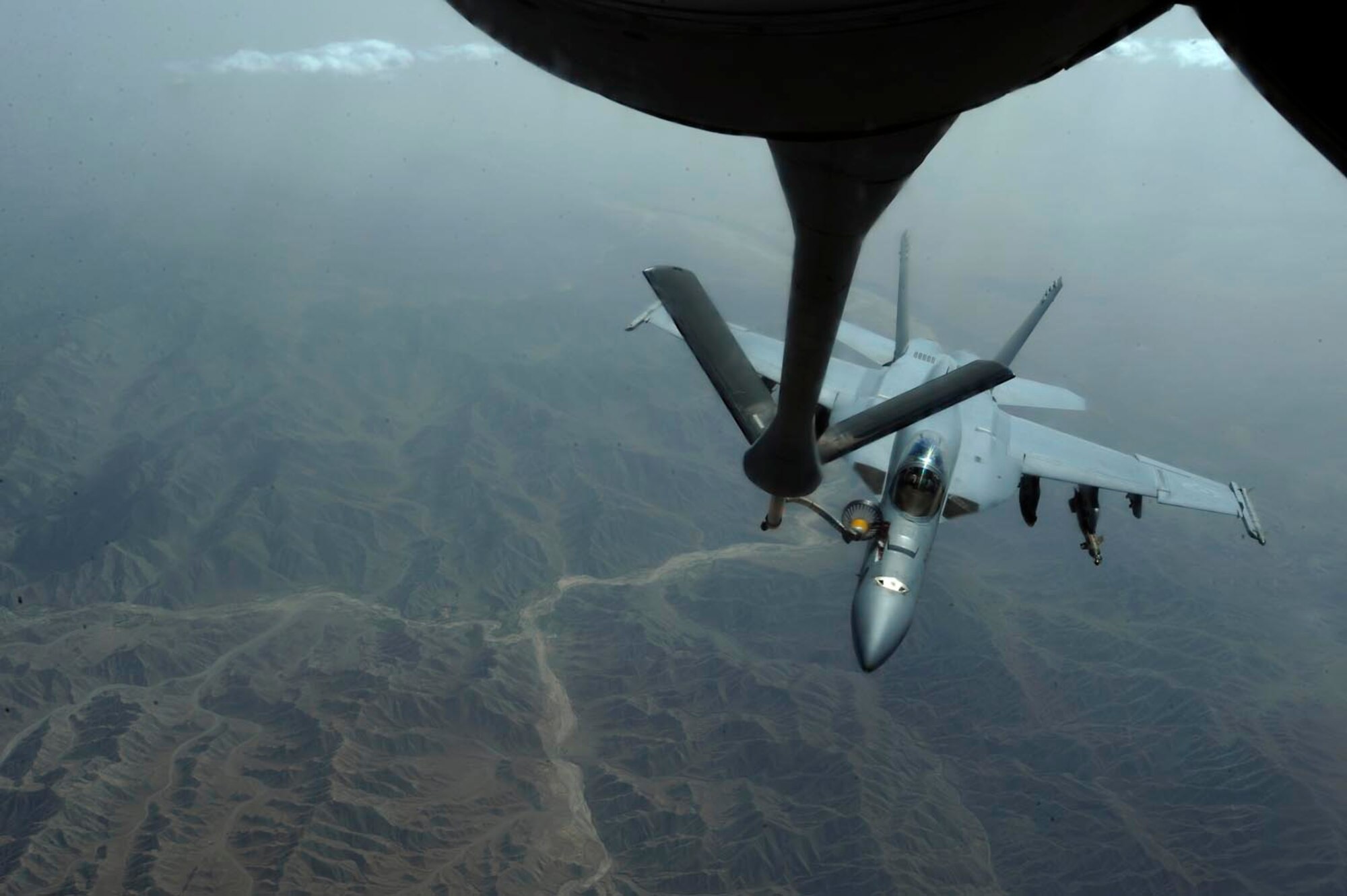 A KC-135 Stratotanker from the 379th Expeditionary Air Refueling Squadron refuels a Navy F-18F Hornet over Afghanistan, July 30, 2009, in support of Operation Enduring Freedom. The KC-135 is one of the aircraft Air Mobility Command and the Air Force has to help the Air Force to "fly, fight and win...in air, space and cyberspace." (U.S. Air Force Photo/Staff Sgt. Michael B. Keller) 
