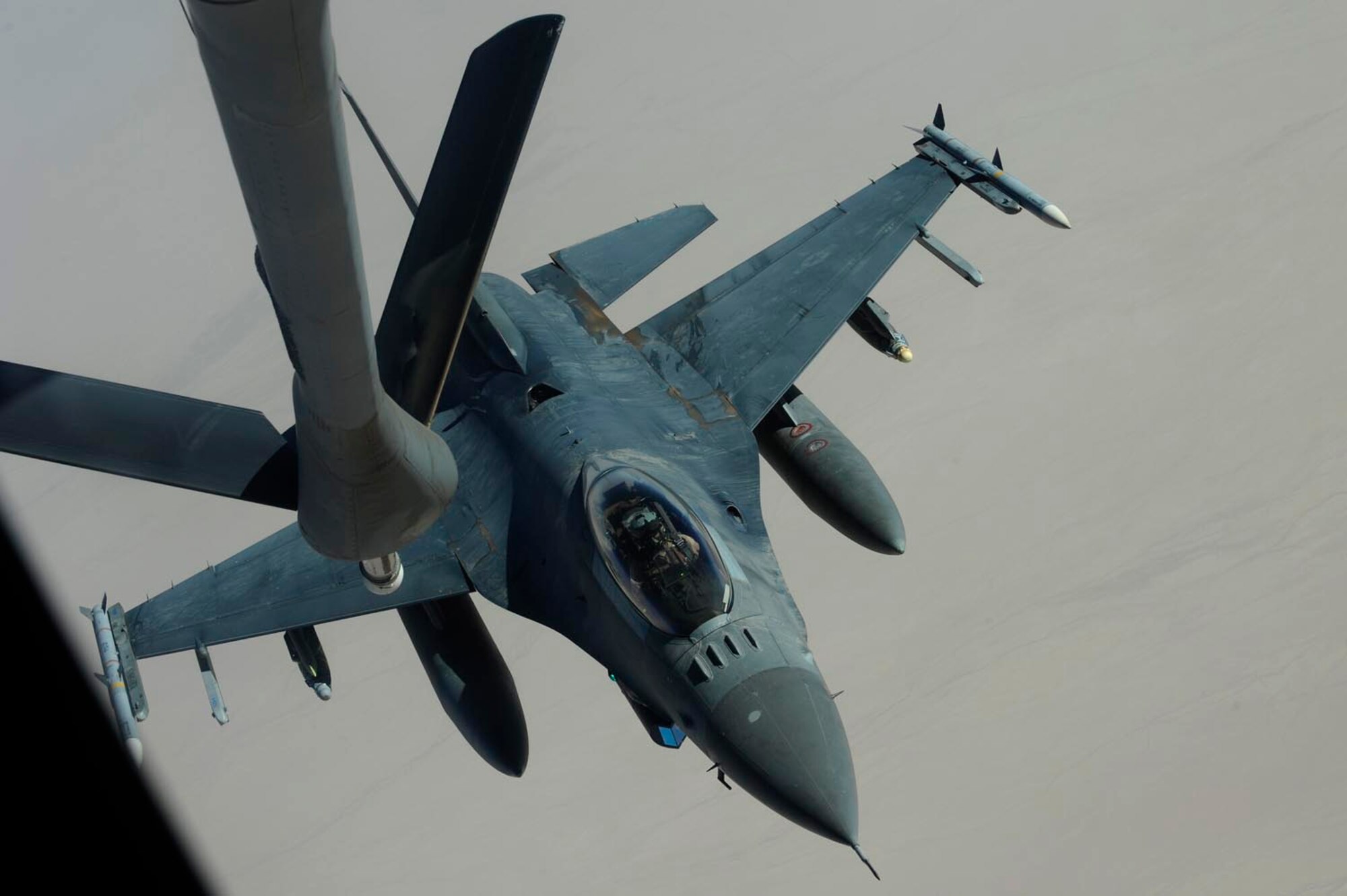 A KC-135 Stratotanker from the 379th Air Expeditionary Refueling Squadron refuels an F-16CJ Fighting Falcon somewhere over Iraq, July 28, 2009.  The KC-135 is one of the aircraft Air Mobility Command and the Air Force has to help the Air Force to "fly, fight and win...in air, space and cyberspace." (U.S. Air Force Photo/Staff Sgt. Michael B. Keller) 

