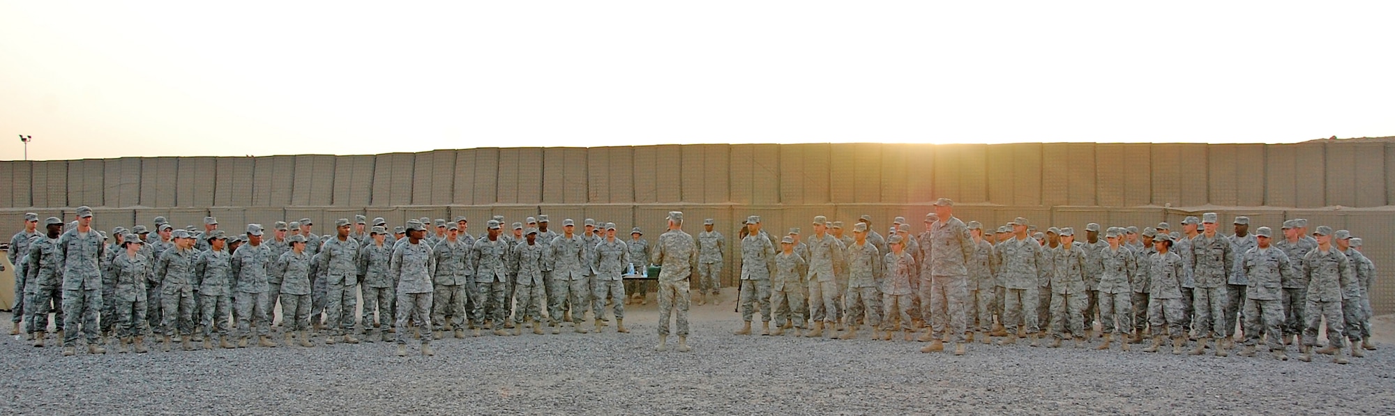 Members of the 887th Expeditionary Security Forces Squadron stand in formation at an end-of-tour ceremony Aug. 10 at Camp Bucca, Iraq. The Airmen were recognized for their work in support of visitation operations. (U.S. Air Force photo/Staff Sgt. Shaun Emery)
 
