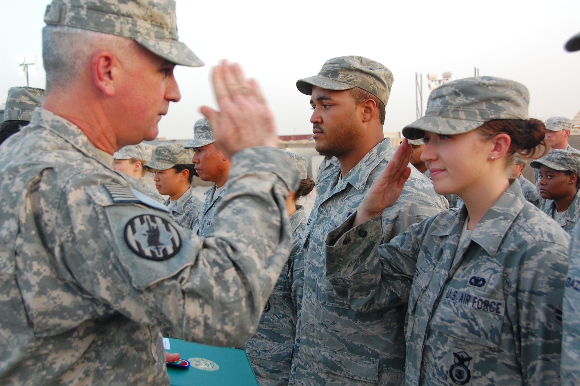 Airman 1st Class Jordan Barth renders a salute to Army Lt. Col. Brad Bishop after receiving a certificate of appreciation during an end-of-tour ceremony Aug. 10 at Camp Bucca, Iraq. More than 120 Airmen from the 887th Expeditionary Security Forces were recognized for their work in visitation operations while deployed here. Airman Barth, an 887th ESFS controller, is deployed from Schreiver Air Force Base, Colo. Colonel Bishop is the 168th Military Police Battalion commander. (U.S. Air Force photo/Staff Sgt. Shaun Emery) 