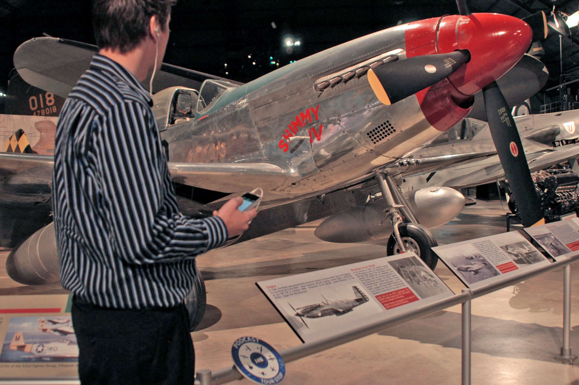 A visitor listens to a museum tour podcast segment at the National Museum of the U.S. Air Force in Dayton, Ohio. (U.S. Air Force photo)