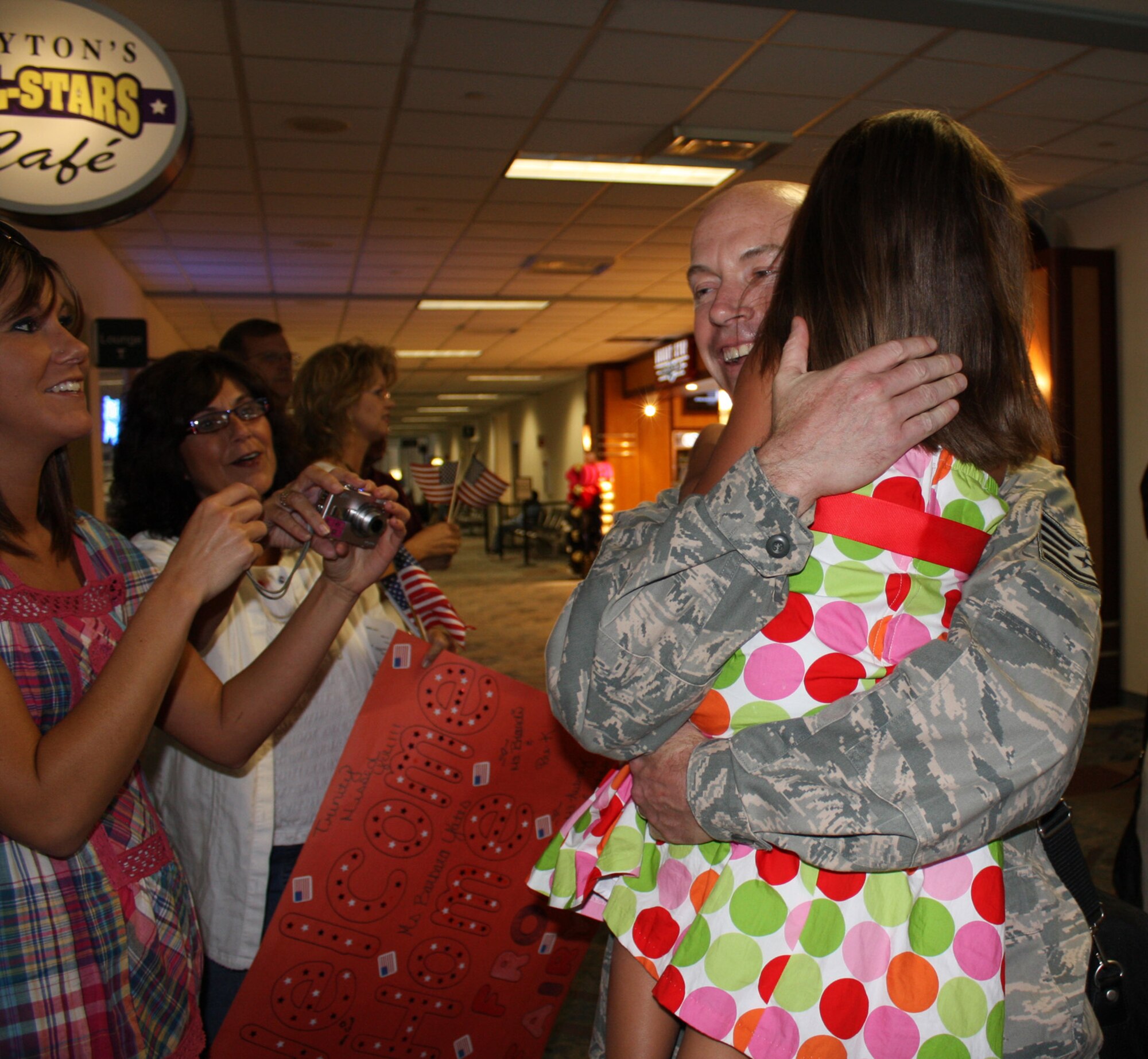 WRIGHT-PATTERSON AIR FORCE BASE, Ohio – Tech. Sgt. Brian Algeo, 445th Security Forces Squadron, is greeted by family and friends at the Dayton International Airport Aug. 6 after returning from a 6-month deployment to Southwest Asia.  Sergeant Algeo and 11 reservists from the SFS were replaced by fellow reservists from their squadron that left here in July. (U. S. Air Force photo/Stacy Vaughn)