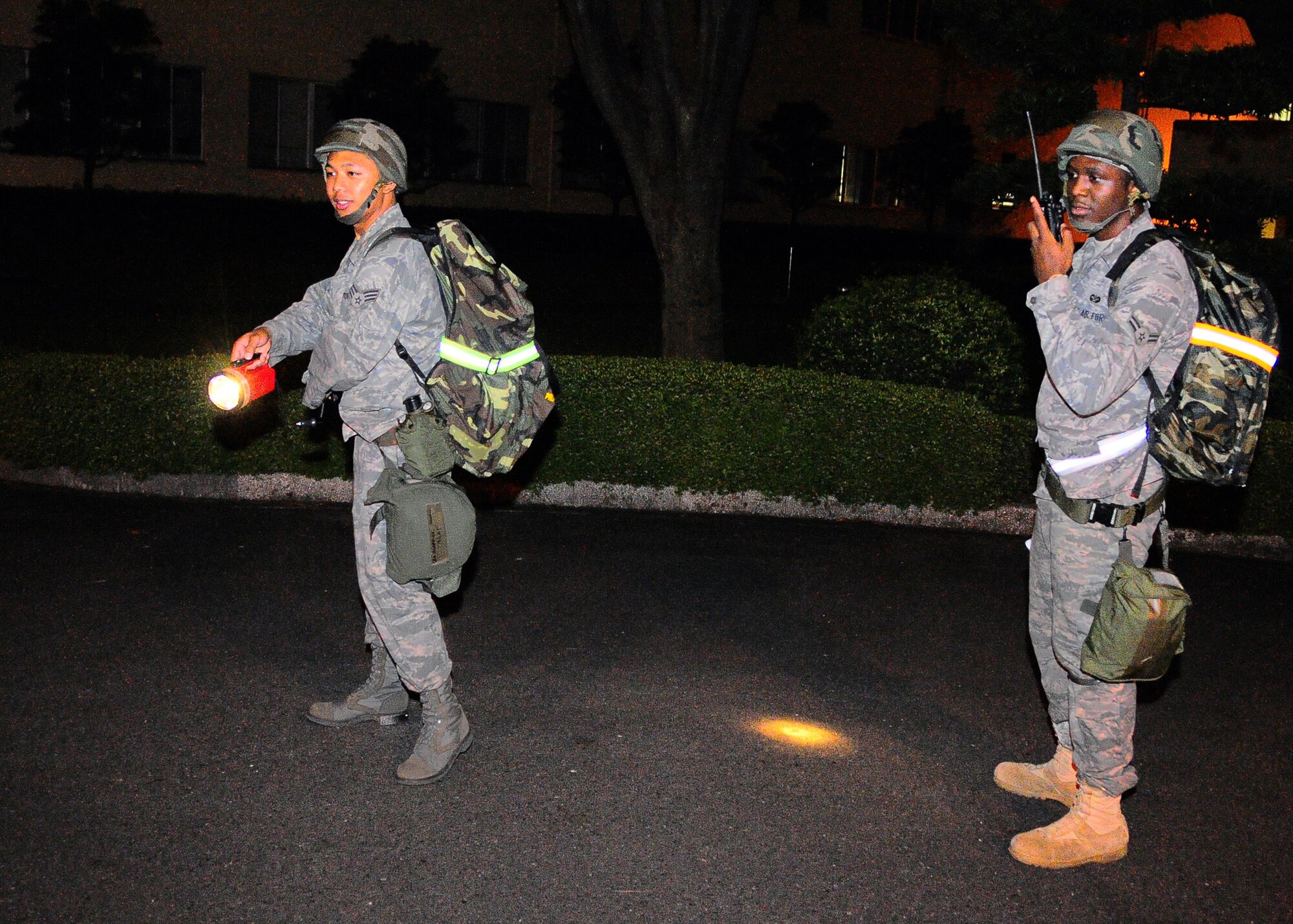 YOKOTA AIR BASE, Japan -- Senior Airman Mario Marquez and Airman 1st Class Arthur Harris, 374th Airlift Wing, conduct post attack reconnaissance outside bldg 315 during exercise Beverly Morning 09-06, Aug 12.Yokota is conducting a phase l and ll exercise Aug. 11-14 to prepare for an upcoming operational readiness inspection. (U.S. Air Force photo/Airman 1st Class Michael Dillon) 
