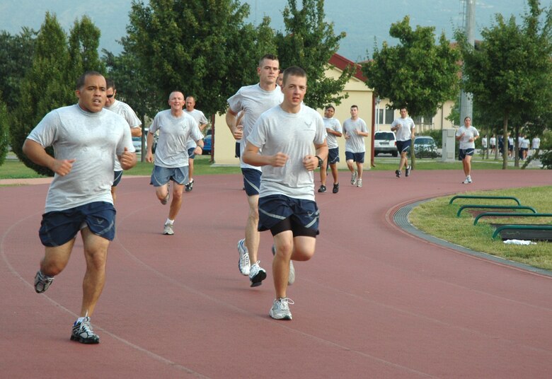 Aviano Airmen run laps around the base track Aug. 12, 2009 as part of their morning physical training session. The 31st Fighter Wing was recently deemed the winner of the U.S. Air Forces in Europe Body Mass Index Challenge that ran from December 2008 thru June 2009, going from 26.13 to 25.83 for a 0.3 percent loss between the first and second weigh-in. The base was awarded $300,000 from the contest to use toward quality of life projects. (U.S. Air Force photo/Staff Sgt. Mercedes Crossland)