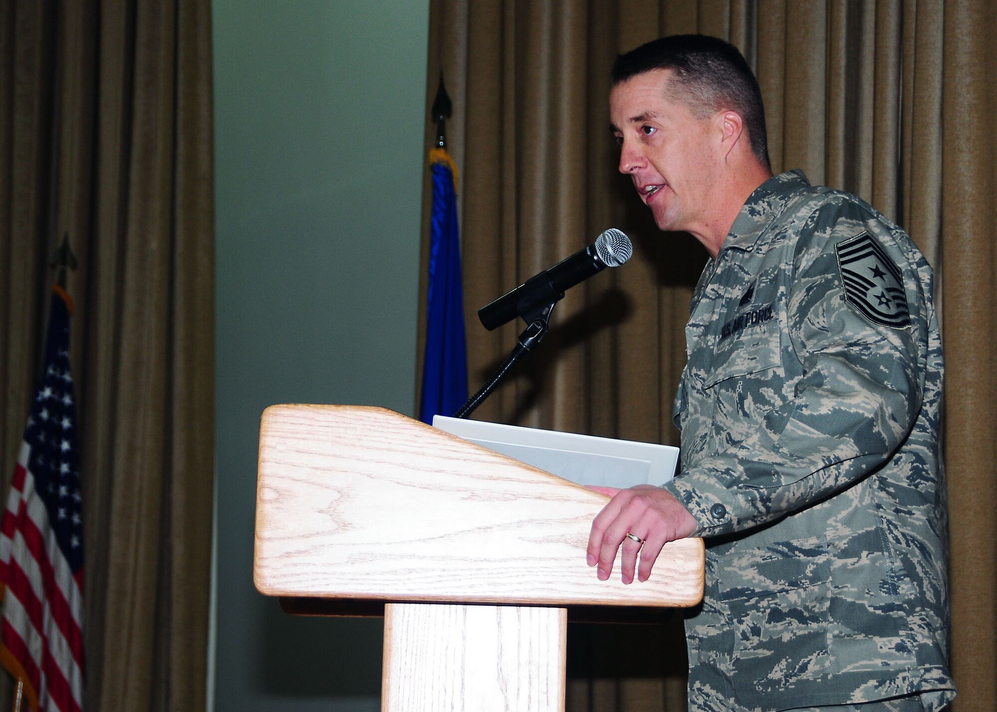 SOUTHWEST ASIA -- Chief Master Sgt. Douglas L. McIntyre,  386th Air Expeditionary Wing command chief, addresses the crowd during the senior non-commissioned officer induction ceremony held here  Aug. 8. Thirteen NCOs from the 386th AEW were inducted into the Senior NCO corps during the tradition-rich ceremony. (U.S. Air Force photo/Tech. Sgt. Tony Tolley) 