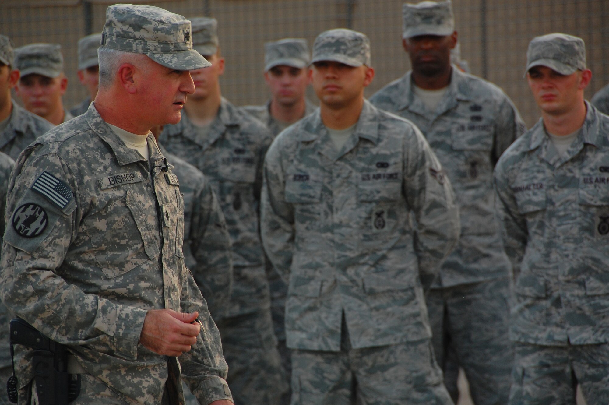CAMP BUCCA, Iraq ? Army Lt. Col. Brad Bishop, 168th Military Police Battalion commander, addresses members of the 887th Expeditionary Security Forces Squadron during an end of tour ceremony Aug. 10 at Camp Bucca, Iraq. The Airmen are members of the Air Force Detainee Visitation Team.  Visitation operations allowed families of detainees access to the base to visit their loved ones. (U.S. Air Force photo/Staff Sgt. Shaun Emery)