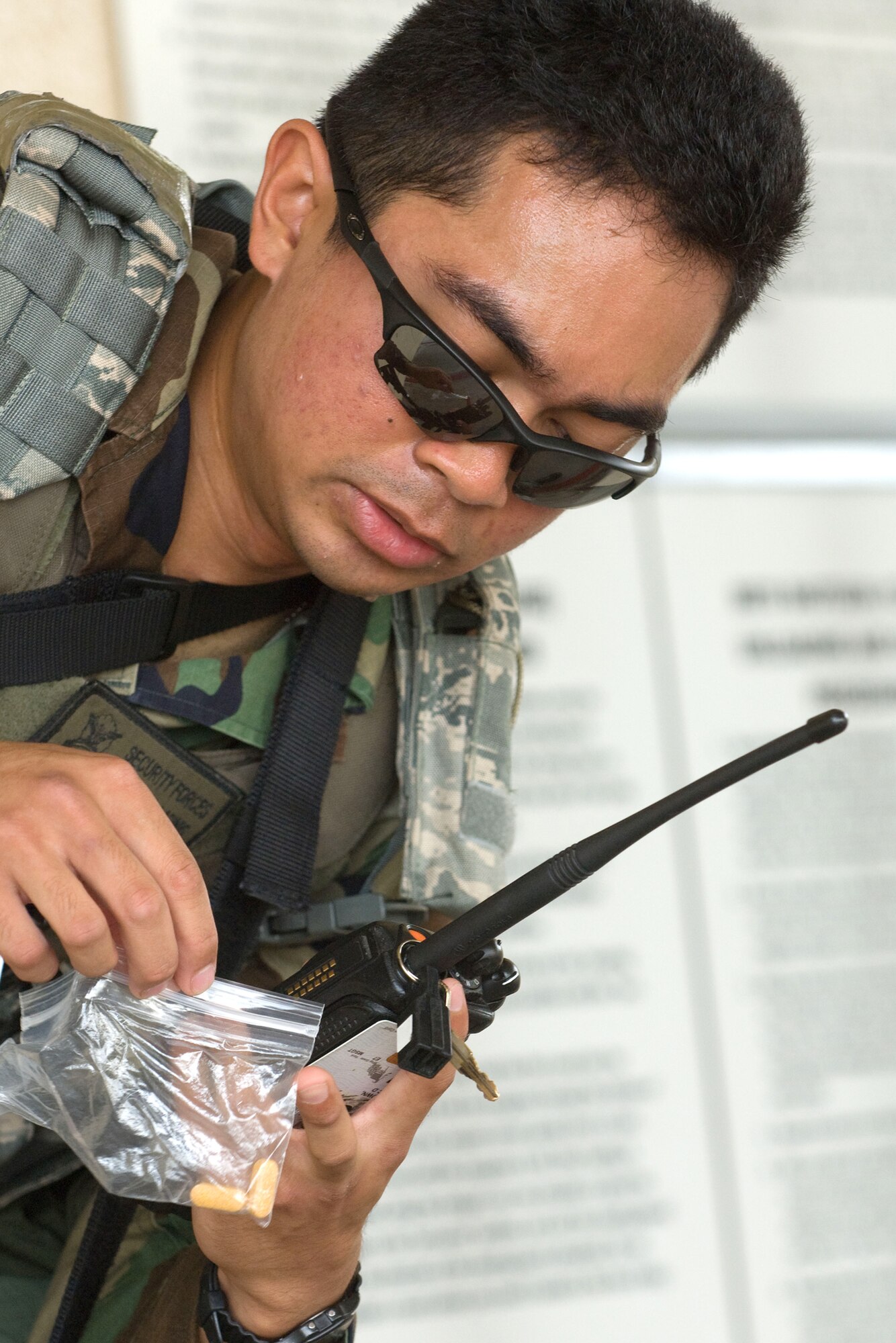 YOKOTA AIR BASE, Japan -- Airman 1st Class Francis Lapinig, 374th Security Force Squadron, reports a simulated suspicious substance to Low and Enforcement desk by a radio Aug. 12 during Phase 1 Exercise Beverly Morning 09-06. (U.S. Air Force photo/Osakabe Yasuo)