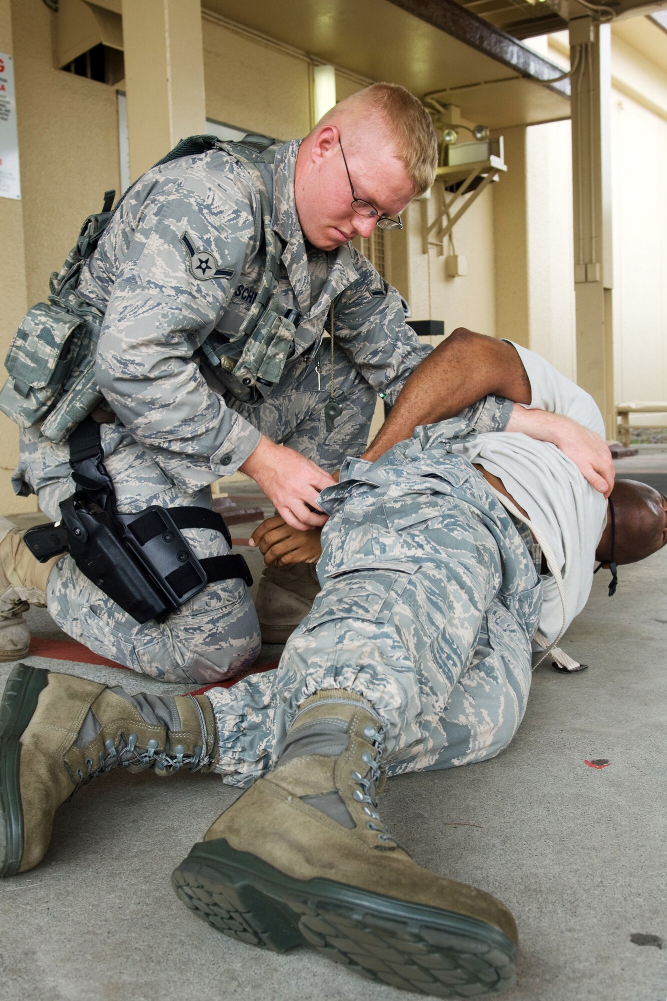 YOKOTA AIR BASE, Japan -- Airman Brian Schmidt, 374th Security Forces Squadron, performs a simulated body searches to flightline intruder, Aug. 12, during Phase 1 Exercise Beverly Morning 09-06. (U.S. Air Force photo/Osakabe Yasuo)