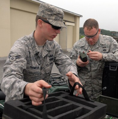 MISAWA AIR BASE, Japan – Airman 1st Class Matthew Thompson and Tech. Sgt. Rory Stark, 35th Civil Engineer Squadron explosive ordnance disposal technicians, inspect receivers prior to using them in the field Aug. 7 at Draughon Range. The receivers are used to detonate the C4 remotely. This allows EOD members to withdraw to a safe distance before detonation. (Air Force photo/Staff Sgt. Phillip Butterfield) 

