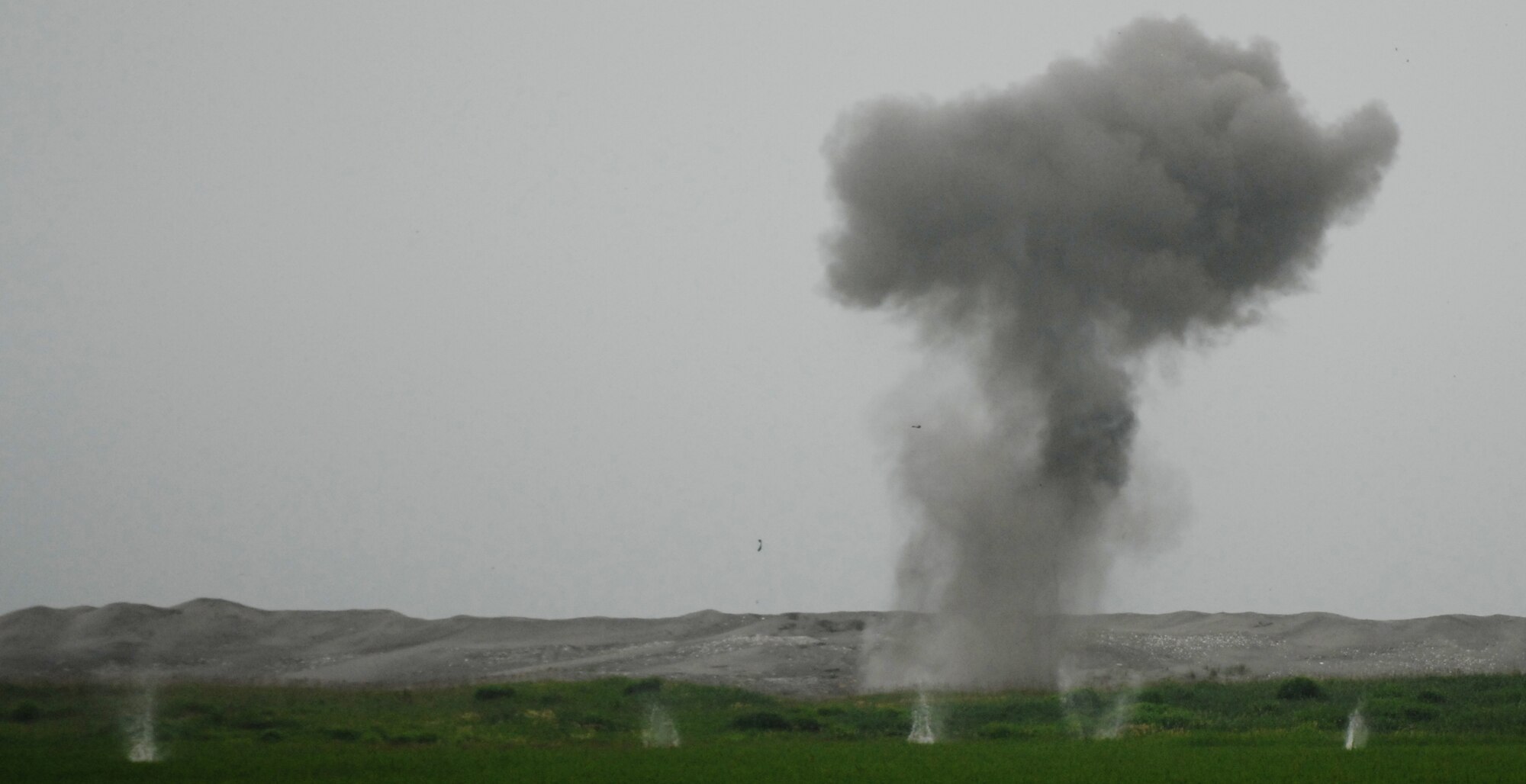 MISAWA AIR BASE, Japan – Remnants of bomb dummy unit rain down after a detonation Aug.7 at Draughon Range. Two types of training bombs were detonated using C4 explosive to make the bombs safe for salvage. (Air Force photo/Staff Sgt. Phillip Butterfield)

