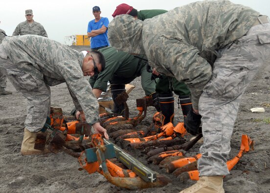 MISAWA AIR BASE, Japan – Tech. Sgts. Felipe Lucero and Rory Stark, 35th Civil Engineer Squadron explosive ordnance disposal technicians, prepare bomb dummy unit for detonation Aug. 7 at Draughon Range. EOD technicians use C4 to destroy the hazardous munitions in an effort to make them safe for salvage. (Air Force photo/Staff Sgt. Phillip Butterfield) 
