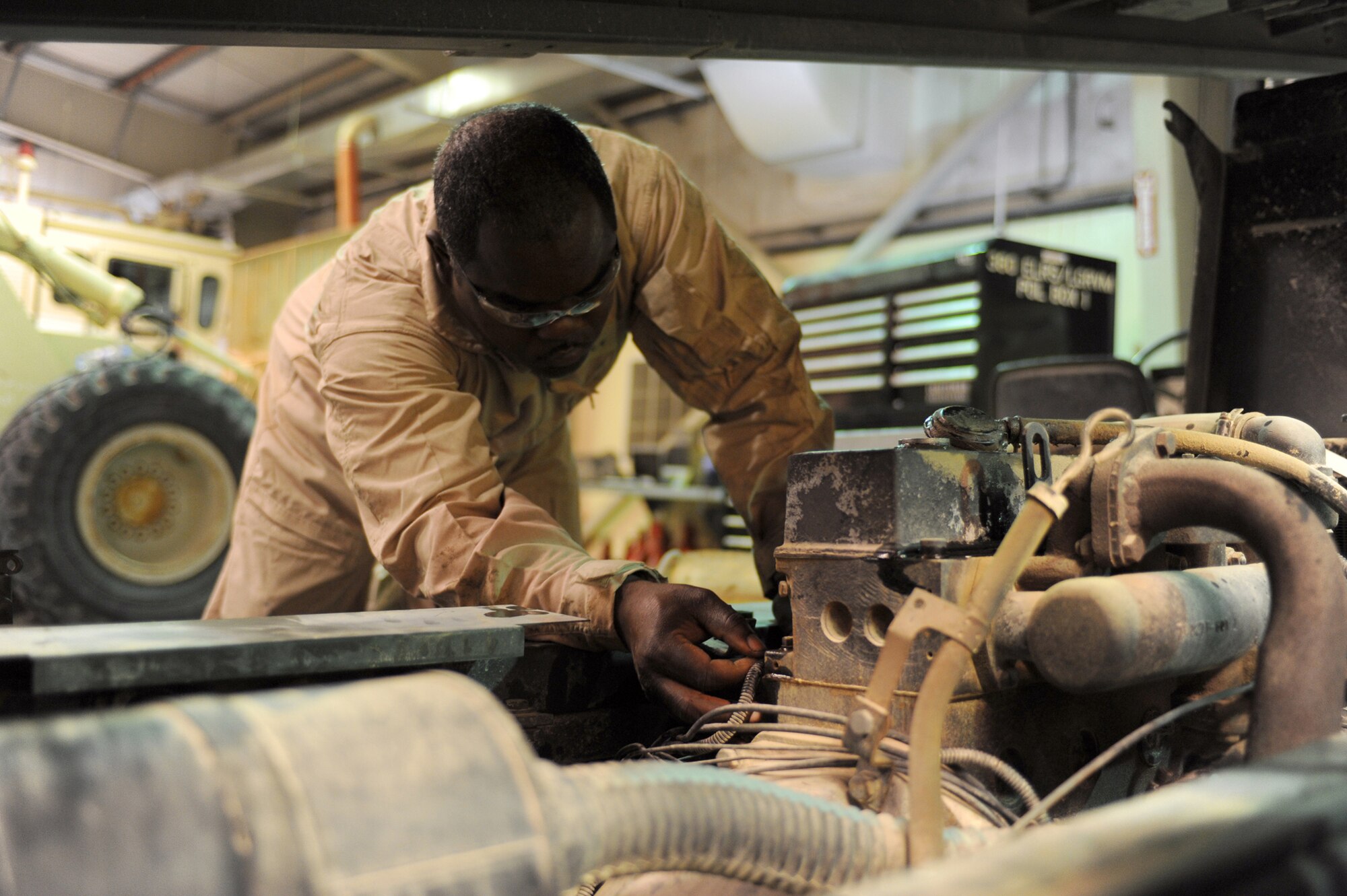 SOUTHWEST ASIA -Staff Sgt. Derrick Wallace, 380th Expeditionary Logistics Readiness Squadron, performs annual maintenance on a baggage conveyor Aug 11. Sergeant Wallace, is a heavy vehicle mechanic deployed from the 106th Rescue Wing at Gabreski Airfield, N.Y., and hails from Queens, N.Y. (U.S. Air Force photo/Tech. Sgt. Charles Larkin Sr)