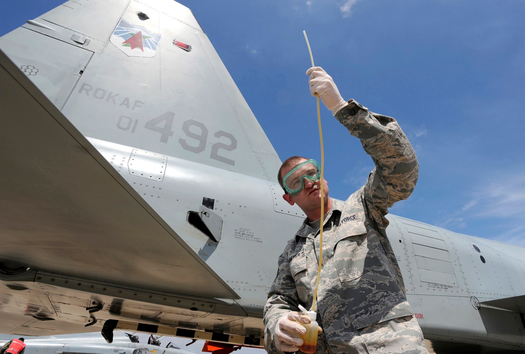 Staff Sgt. Trenton Schreyer checks the oil in an F-5 Tiger II engines at Osan Air Base, Republic of Korea, Aug. 10. He is servicing the F-5 as part of the Osan Combat Cross Servicing Program. The program is a mutual agreement between the U.S. and Republic of Korea that allows the maintainers from both services to get hands-on experience working on each other's aircraft. (U.S. Air Force photo/Staff Sgt. Brian Ferguson)

 
