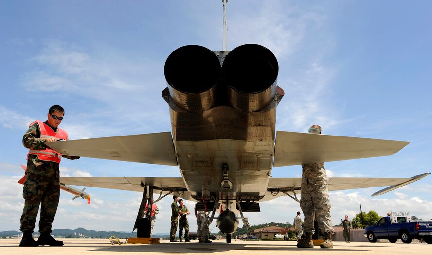 (Left) Staff Sgt. James Hohlt and Staff Sgt. Trenton Schreyer recover an F-5 Tiger II at Osan Air Base, Republic of Korea, Aug. 10.  They are servicing the F-5 as part of the Osan Combat Cross Servicing Program.  The program is a mutual agreement between the U.S. and Republic of Korea that allows the maintainers from both services to get hands-on experience working on each other's aircraft. (U.S. Air Force photo/Staff Sgt. Brian Ferguson)

