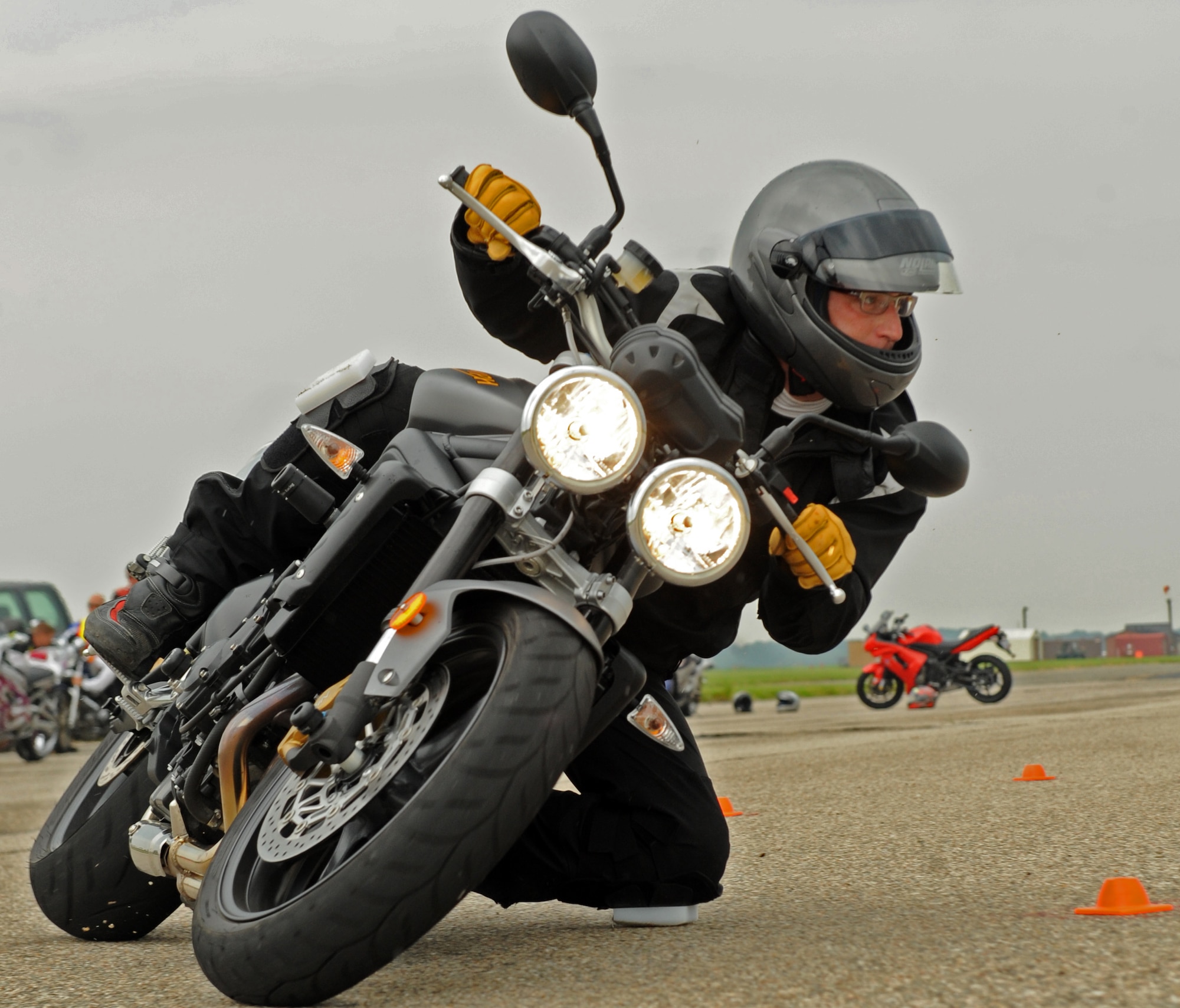 LANGLEY AIR FORCE BASE, Va. -- Lee Parks, Total Control Advanced Riding Clinic chief instructor, leans into a turn here Aug. 7. Mr. Parks runs the Total Control Advanced Riding Clinic to teach riders how to keep control of their vehicle even in the worst of circumstances. (U.S. Air Force photo/Airman 1st Class Jonathan Koob)