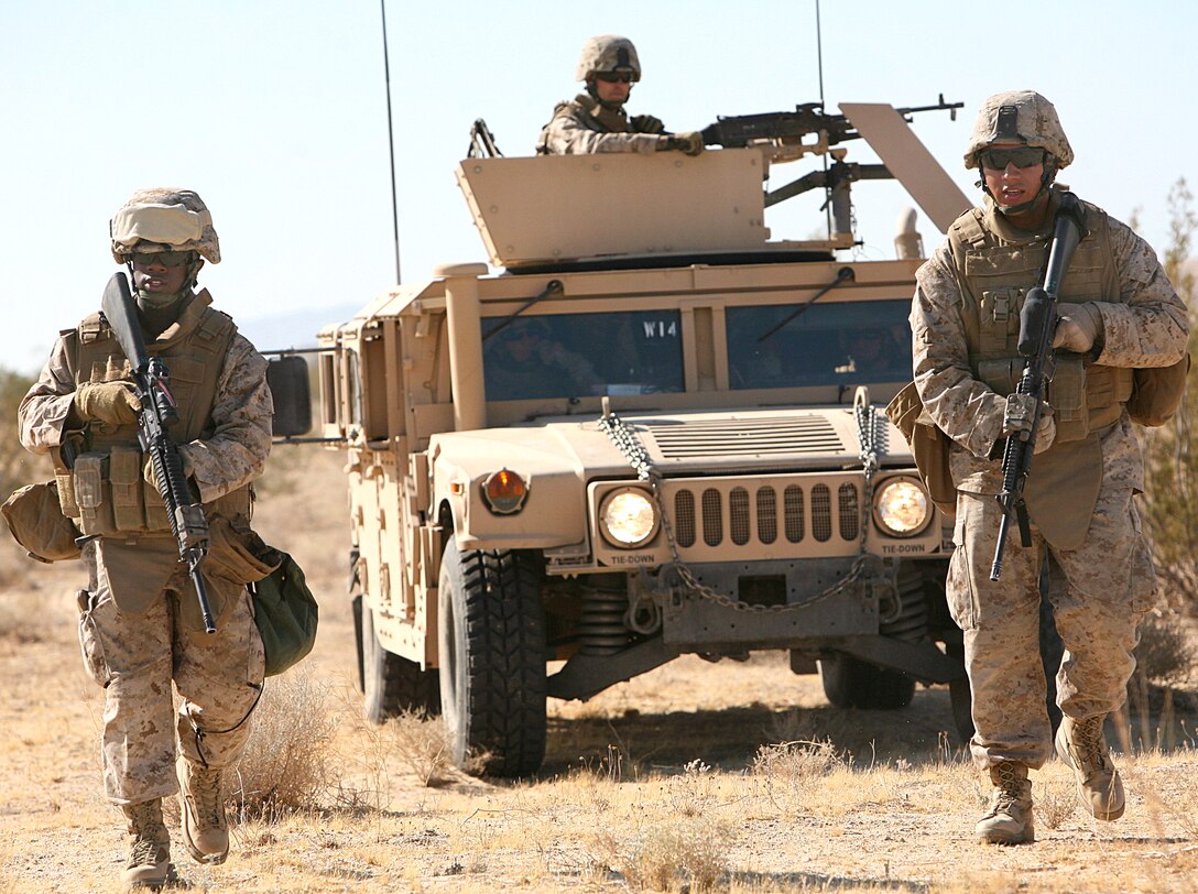U.S. Marine Corps Pfc. Justin Jones and Lance Cpl. Martin Carranza lead their humvee on an alternate route to bypass a possible simulated improvised explosive device as part of their pre-deployment training on Marine Corps Air Ground Combat Center Twentynine Palms, Calif., Aug. 9, 2009. Jones and Carranza are assigned to Headquarters Company, 7th Marine Regiment.