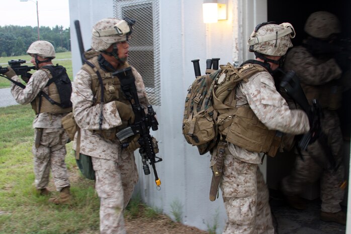 Marines of Bravo Company, Battalion Landing Team 1/9 enter a building to search and clear it during the motorized raid of Cooke Camp aboard U.S. Army Base Fort A.P. Hill, Va. Aug 12.  (U.S. Marine Corps Photo by LCpl. David J. Beall)