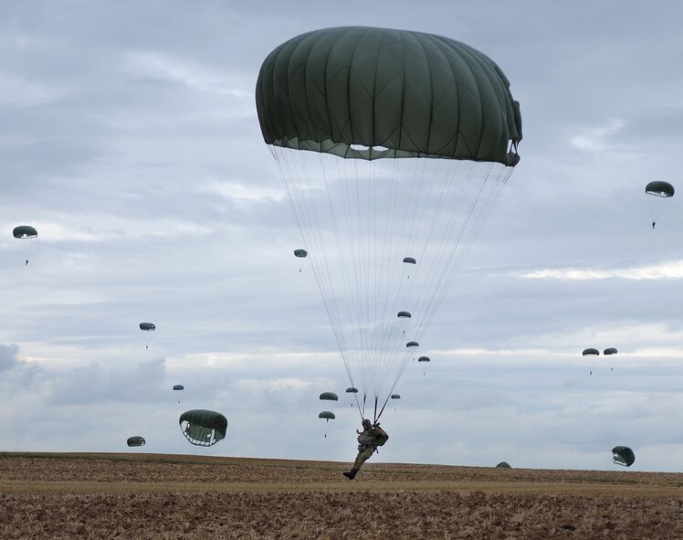 Italian Army soldier Giovanni Cacciari, Italian Airborne, lands after parachuting out of a C-130 Hercules at Bunker drop zone in southwestern, Germany on Aug. 13, 2009. U.S. soldiers and Airmen performed a combined airborne drop with four other NATO countries. The German, Italian, Belgium, and Dutch Armies attended the airborne drop during International Jump Week. (U.S. Air Force photo by Airman 1st Class Grovert Fuentes-Contreras) 
