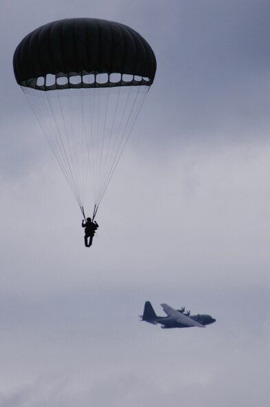 A U.S. soldier parachutes out of a C-130 Hercules over Bunker drop zone in southwestern, Germany on Aug. 13, 2009. U.S. soldiers and Airmen performed a combined airborne jump with four other NATO countries. German, Italian, Belgium, and Dutch armies attended the airborne jump during International Jump Week. (U.S. Air Force photo by Airman 1st Class Grovert Fuentes-Contreras) 
