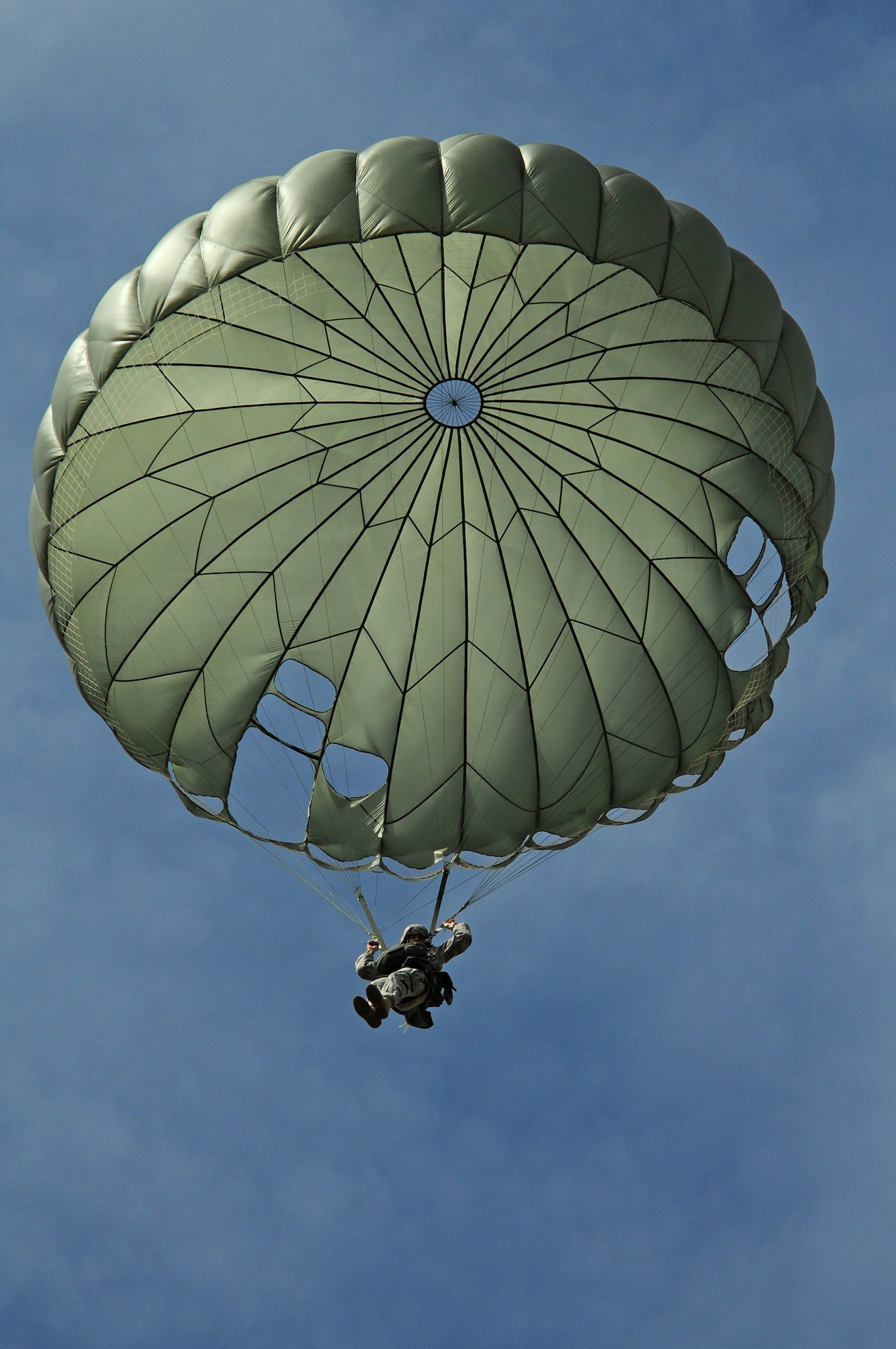 A U.S. soldier parachutes over Bunker drop zone in southwestern, Germany on Aug. 13, 2009.  U.S. soldiers and airmen performed a combined airborne jump with four other NATO countries. German, Italian, Belgium, and Dutch army attended the airborne jump during NATO Jump Week. (U.S. Air Force photo by Airman 1st Class Grovert Fuentes-Contreras)