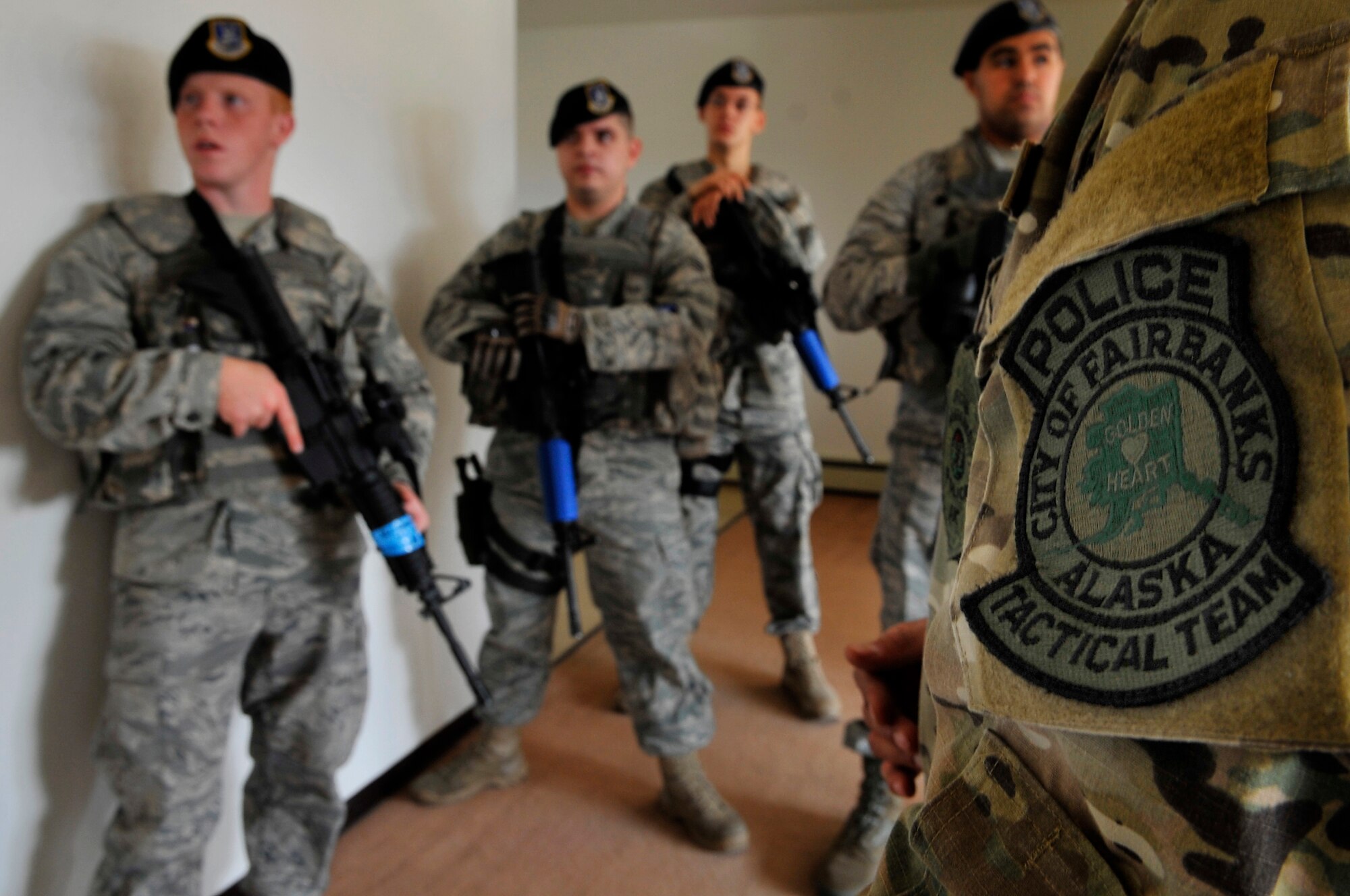Security Forces airmen receive tips and instruction from the Fairbanks Police Tactical Team on close quarter's battle training Aug. 12, 2009, Eielson Air Force Base. The airmen received training and basic knowledge how to handle hostile environments. (U.S. Air Force photo/Staff Sgt. Christopher Boitz)