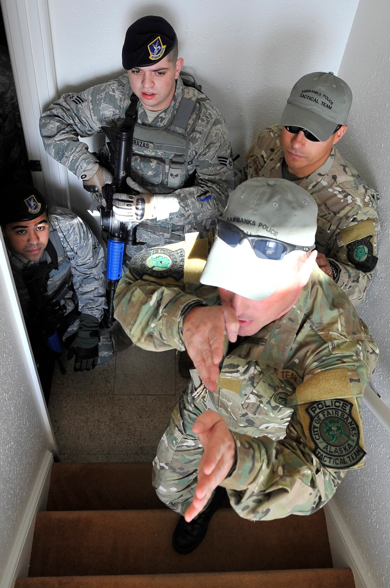 Members from the Fairbanks Police Tactical Team demonstrate how to approach different rooms to Security Forces airmen during close quarter's battle training Aug. 12, 2009, Eielson Air Force Base. The training conducted is used to handle hostile situations with the element of surprise, speed and domination. (U.S. Air Force photo/Staff Sgt. Christopher Boitz)