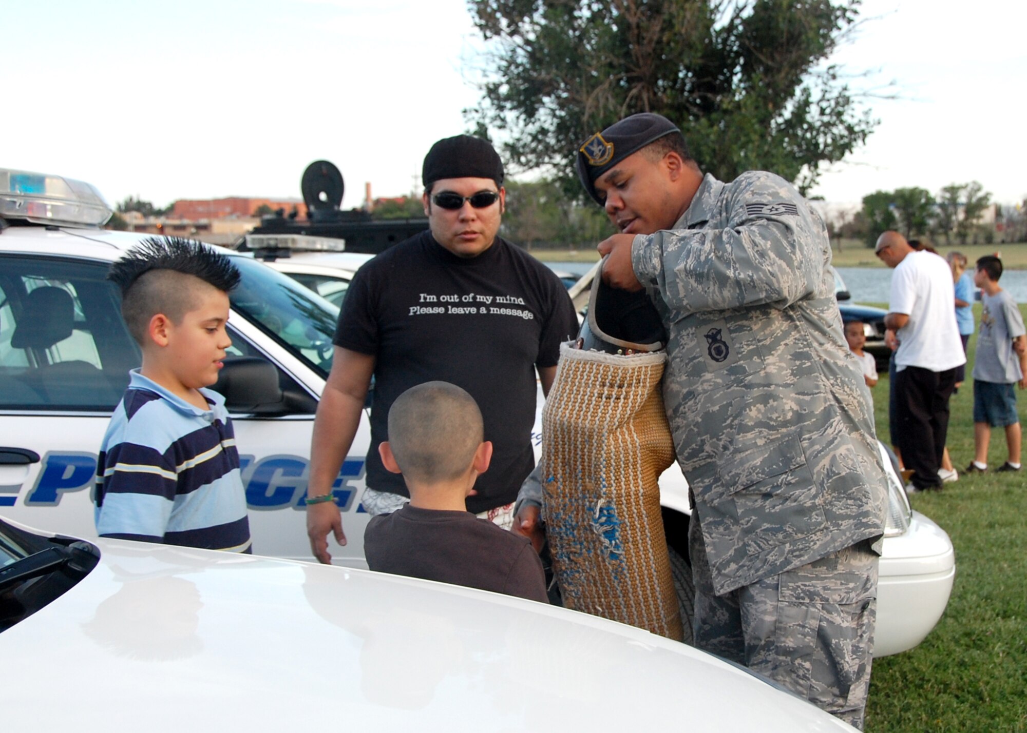 CANNON AIR FORCE BASE, N.M. -- Staff Sgt. Marcus Reaves, 27th Special Operations Security Forces Squadron, shows a wrap K-9 handlers use during Military Working Dog training Aug 4. at National Night Out at Green Acres Park, Clovis N.M. National Night Out is an event where the community and local law enforcement come together in an effort to prevent crime. (Air Force photo by Tech. Sgt. Gloria Wilson)