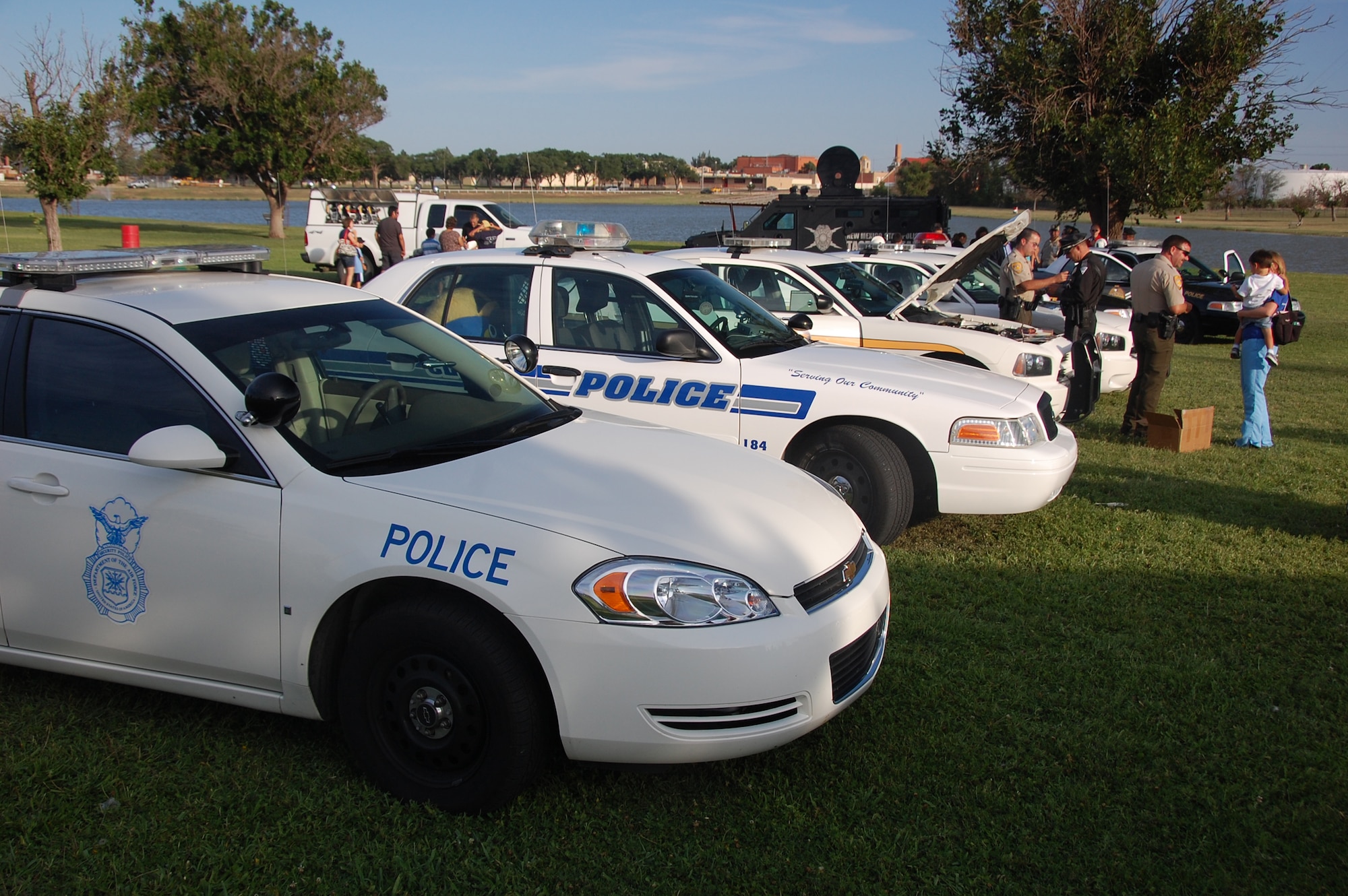 CANNON AIR FORCE BASEM N.M. -- Police vehicles line up for National Night Out Aug. 4 at Green Acres Park in Clovis N.M. The event involved local police agencies including 27th Special Operations Security Forces Squadron Airmen who educated the community on ways to prevent crime. (Air Force photo by Tech. Sgt. Gloria Wilson)