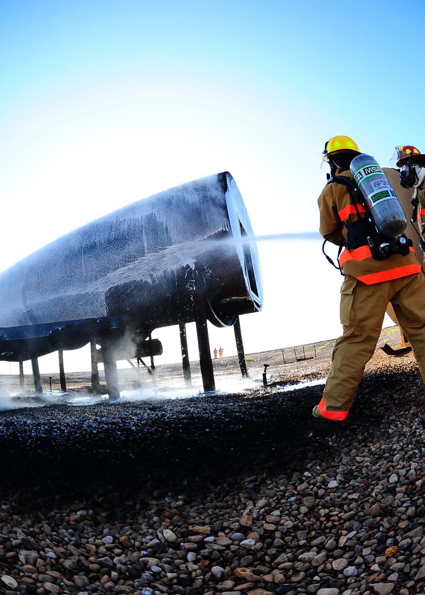 DYESS AIR FORCE BASE, Texas – Airman 1st Class Jonathan Fish, 7th Civil Engineer Squadron fire fighter, extinguishes a burning aircraft at the burn pit here Aug. 11 during a base training exercise. Training exercises help determine how well base personnel are prepared to handle real life threats, and to see what improvements might be made to increase the base’s level of readiness.
