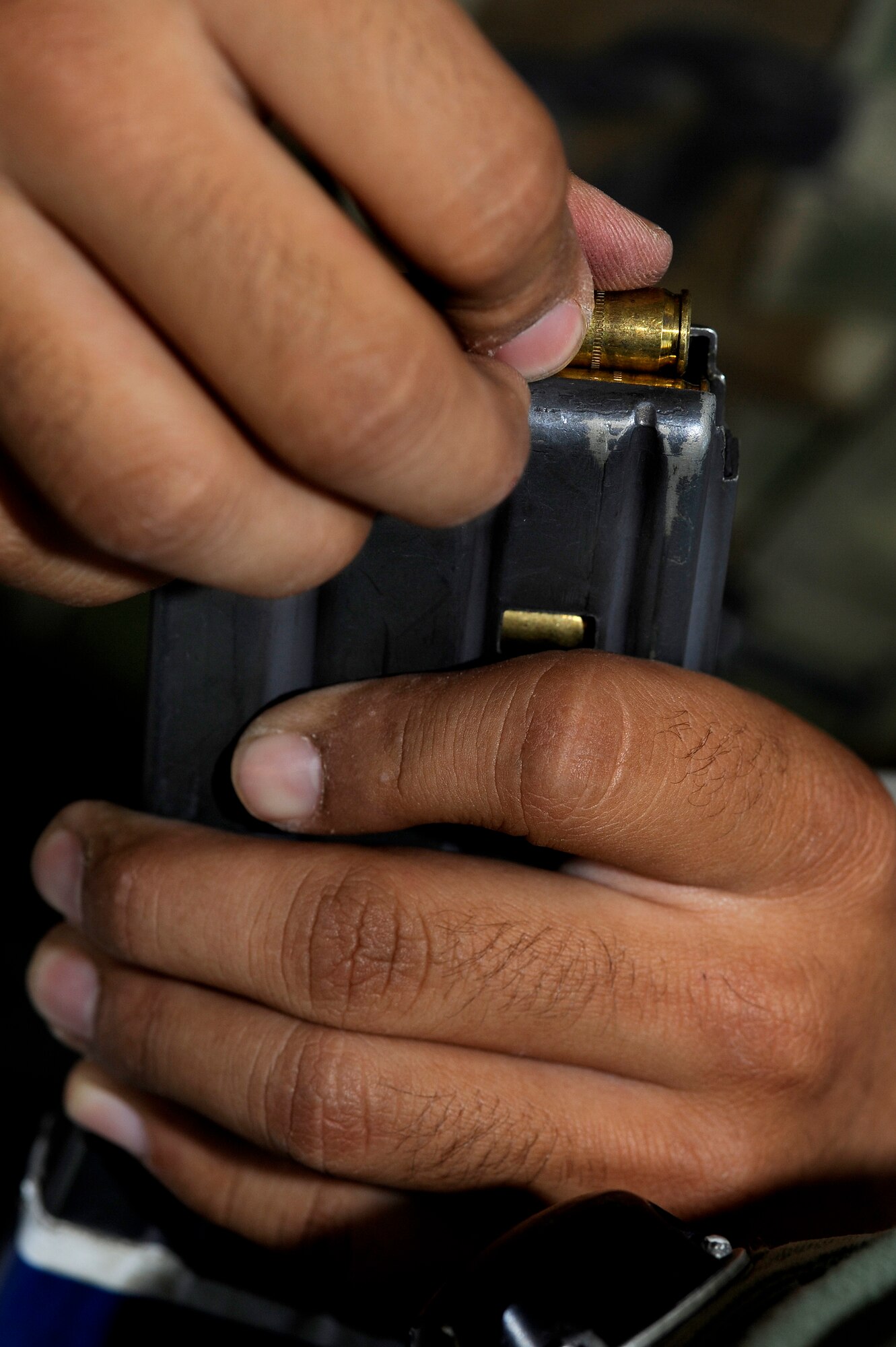 Senior Airman Raymond Gonzales, 460th Civil Engineering Squadron, loads blanks into a magazine during DREST. (U.S. Air Force photo by Senior Airman Steve Czyz)