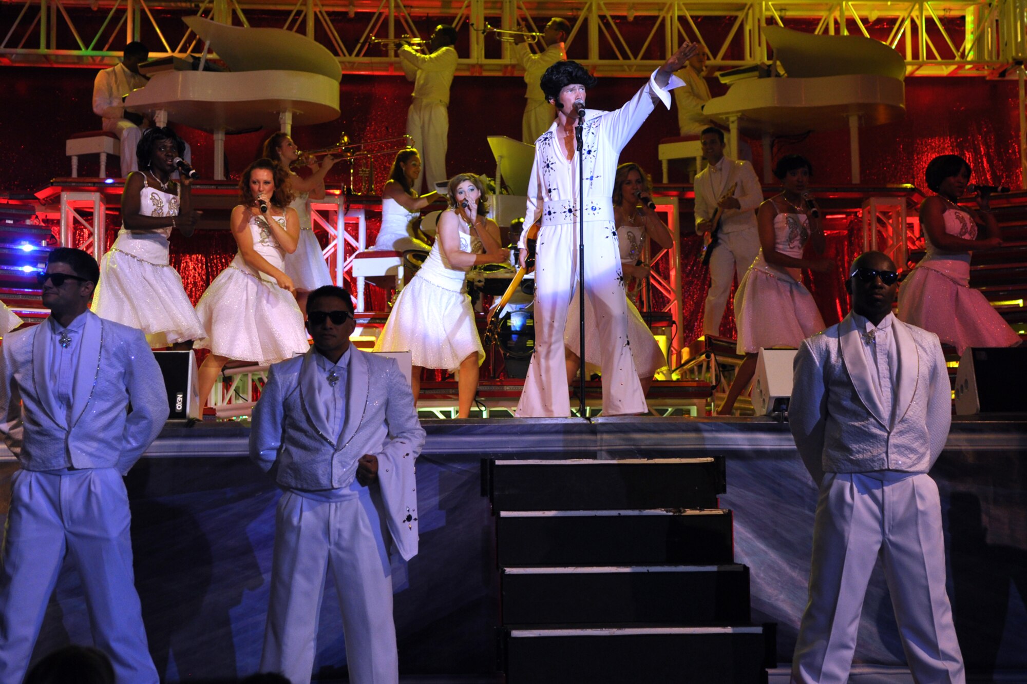 Senior Airman Timothy Womble, aerospace ground equipment journeyman, 437th Maintenance Squadron, Charleston Air Force Base, SC, does his impression of “The King” as his security detail waits for him to “leave the building,” during the  free concert at Hoban Hall on Barksdale Air Force Base, La., August 12, 2009. Tops in Blue, and their Expeditionary Entertainers, have entertained servicemembers and their families, Coalition partners and audiences around the world for 56 years. (U.S. Air Force photo/Tech. Sgt. Jeff Walston)