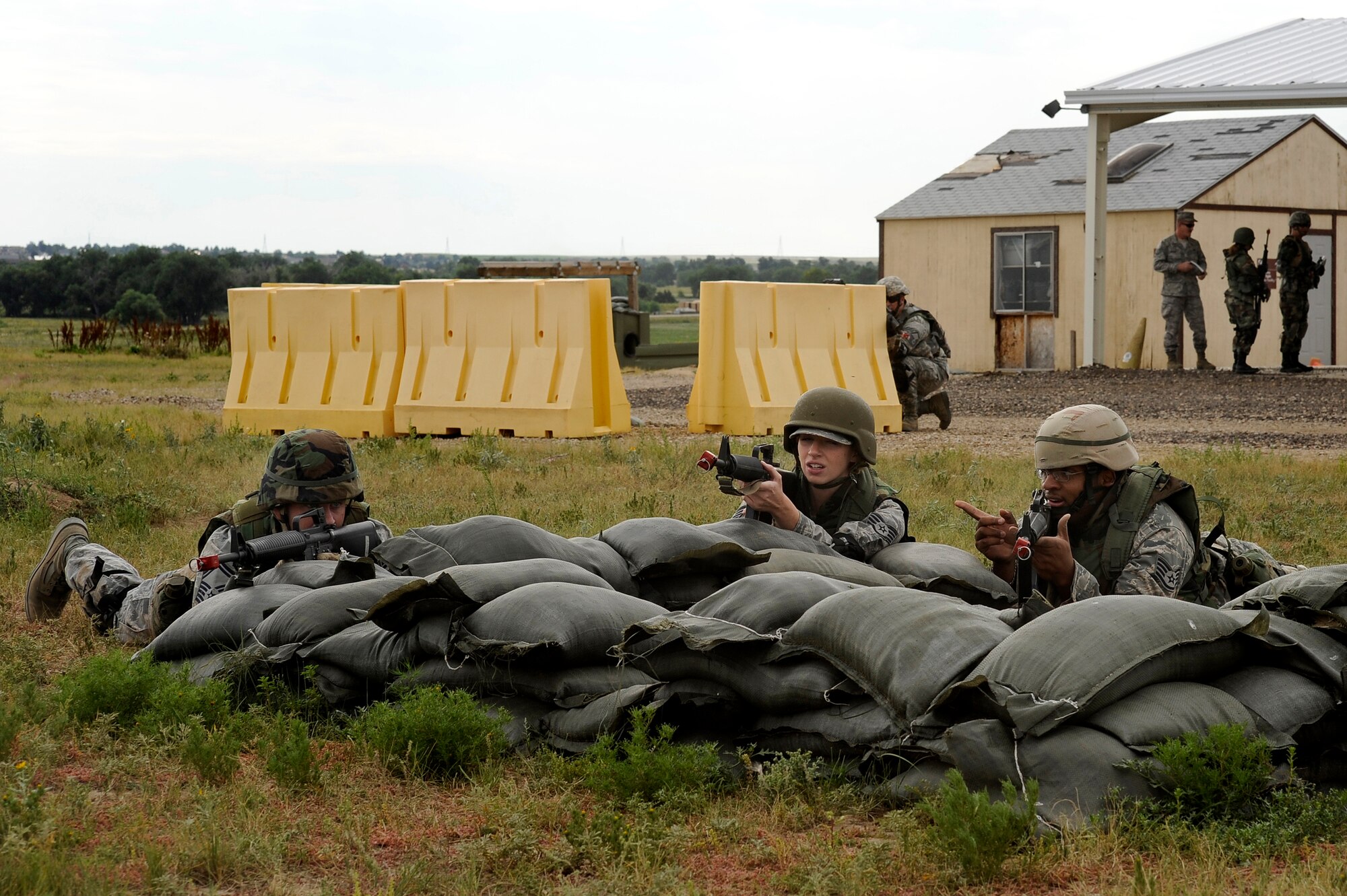 Participants from the 460th Space Wing take cover and return fire during DREST. (U.S. Air Force photo by Senior Airman Steve Czyz)