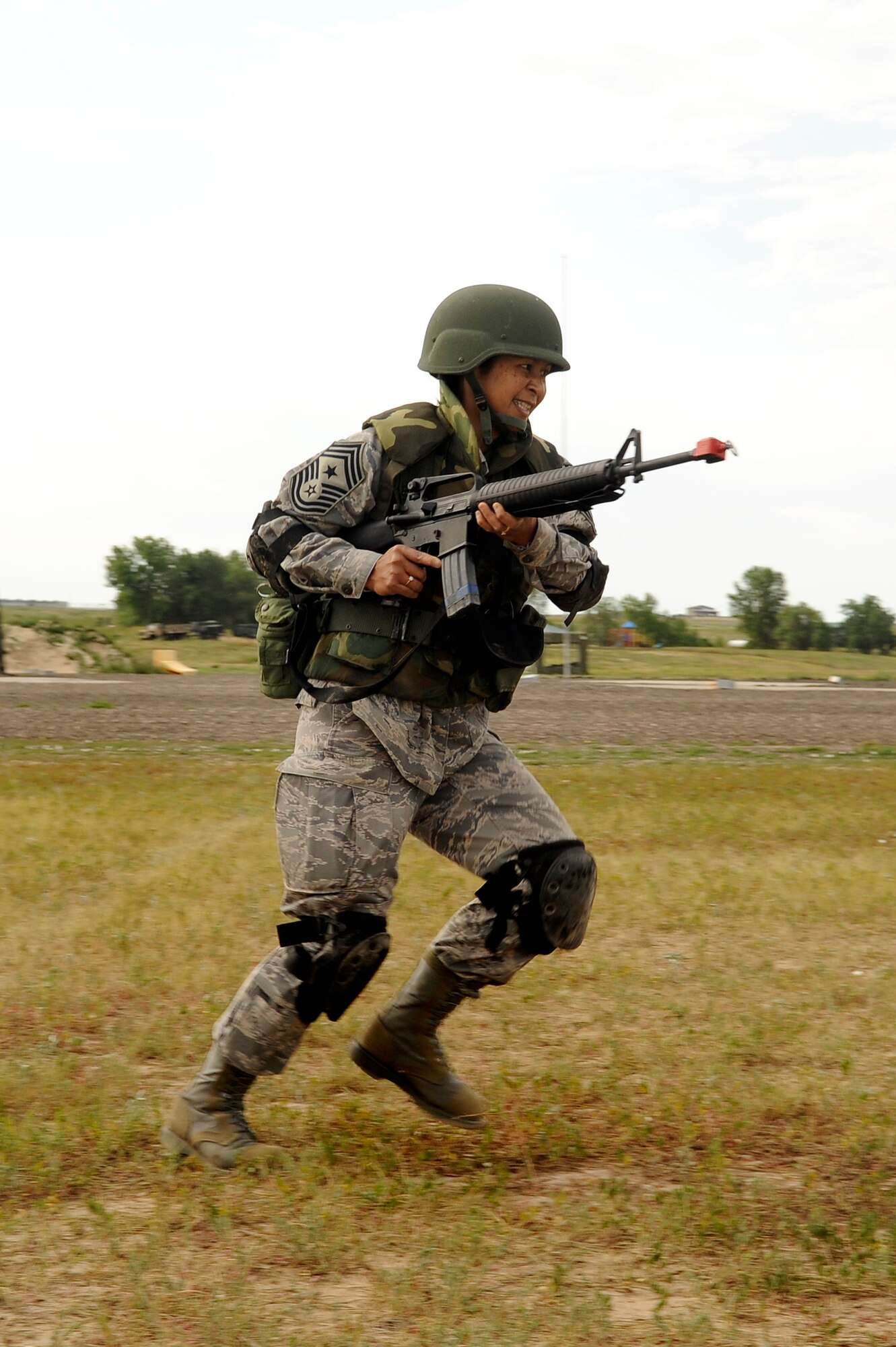 460th Space Wing Command Chief Master Sgt. Arleen Heath runs for cover during DREST Aug. 7. Two days of the three-day course are spent in a field training environment. (U.S. Air Force photo by Senior Airman Steve Czyz)