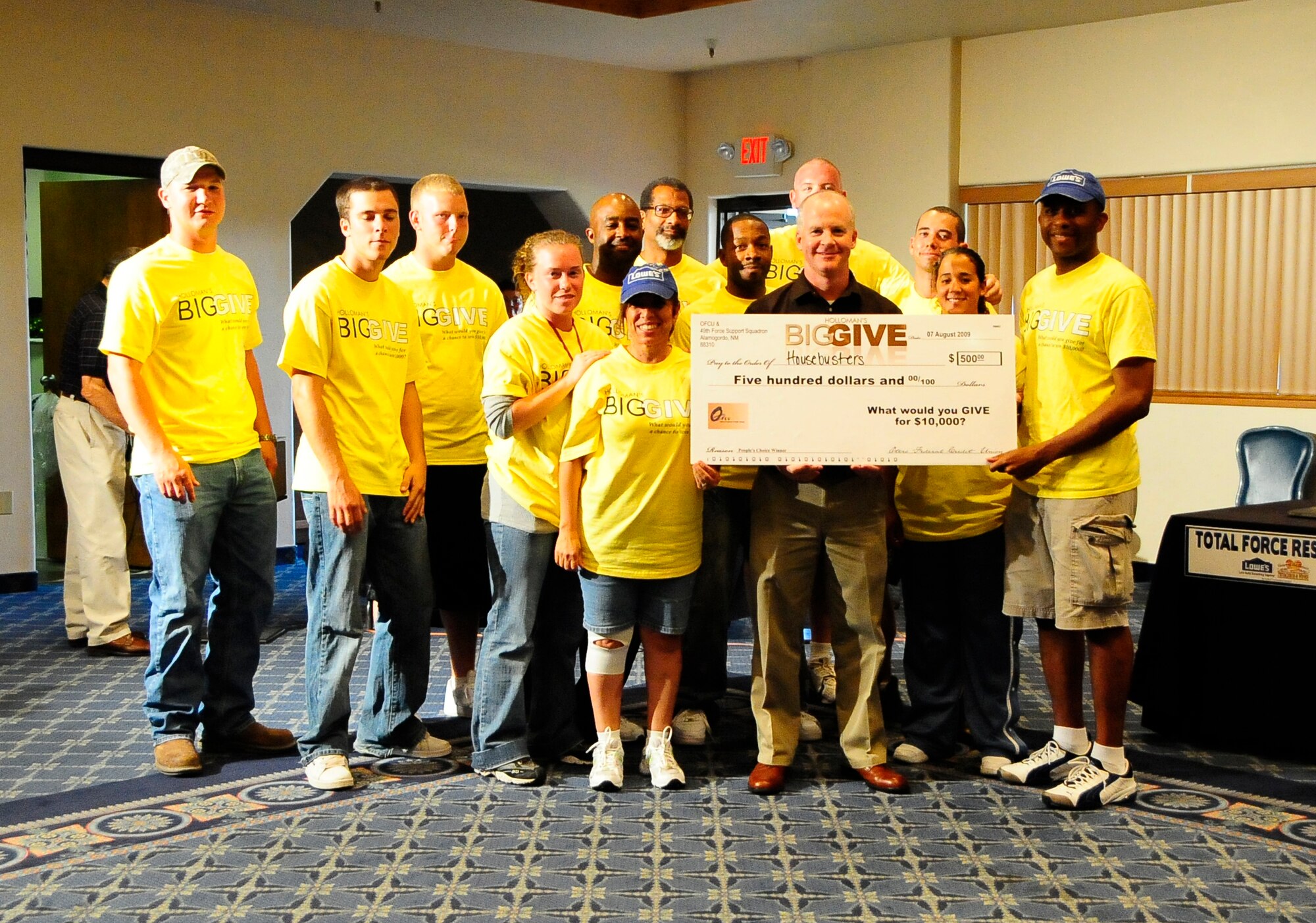 HOLLOMAN AIR FORCE BASE, N.M. -- Team Housebusters is awarded the $500 People?s Choice Award on behalf of Otero Federal Credit Union at the Big Give after-party Aug. 7. Housebusters also received $1,000 from Mesa Verde Enterprises for their renovations on the Disabled American Veterans Center. The team, made-up of mostly civil engineers, did a complete renovation, making the center handicap accessible. (U.S. Air Force photo by Tech. Sgt. Chris Flahive)