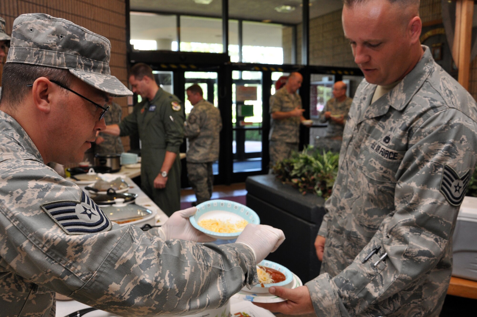 EGLIN AIR FORCE BASE, Fla. – Tech. Sgt. Placido Martinez, 36th Electronic Warfare Squadron, serves up a bowl of “Cheap Chili” at a chili cook off fundraiser, Aug. 13. The cook off, hosted by the 36th EWS, served eight different types of chili as a competition to see who can mix the best blend of ingredients to create a tasty chili concoction. More than $200 went to the 36th EWS unit advisory council’s morale fund. 10 participants competed in four categories including VIP’s choice, hottest, most unique and most popular. The winner received a reserved parking spot for one week. Dishes included, “Almost Bambi,” “Crestview Caliente,” and “White Chicken Chili.” (U.S. Air Force photo/ Airman Anthony Jennings)