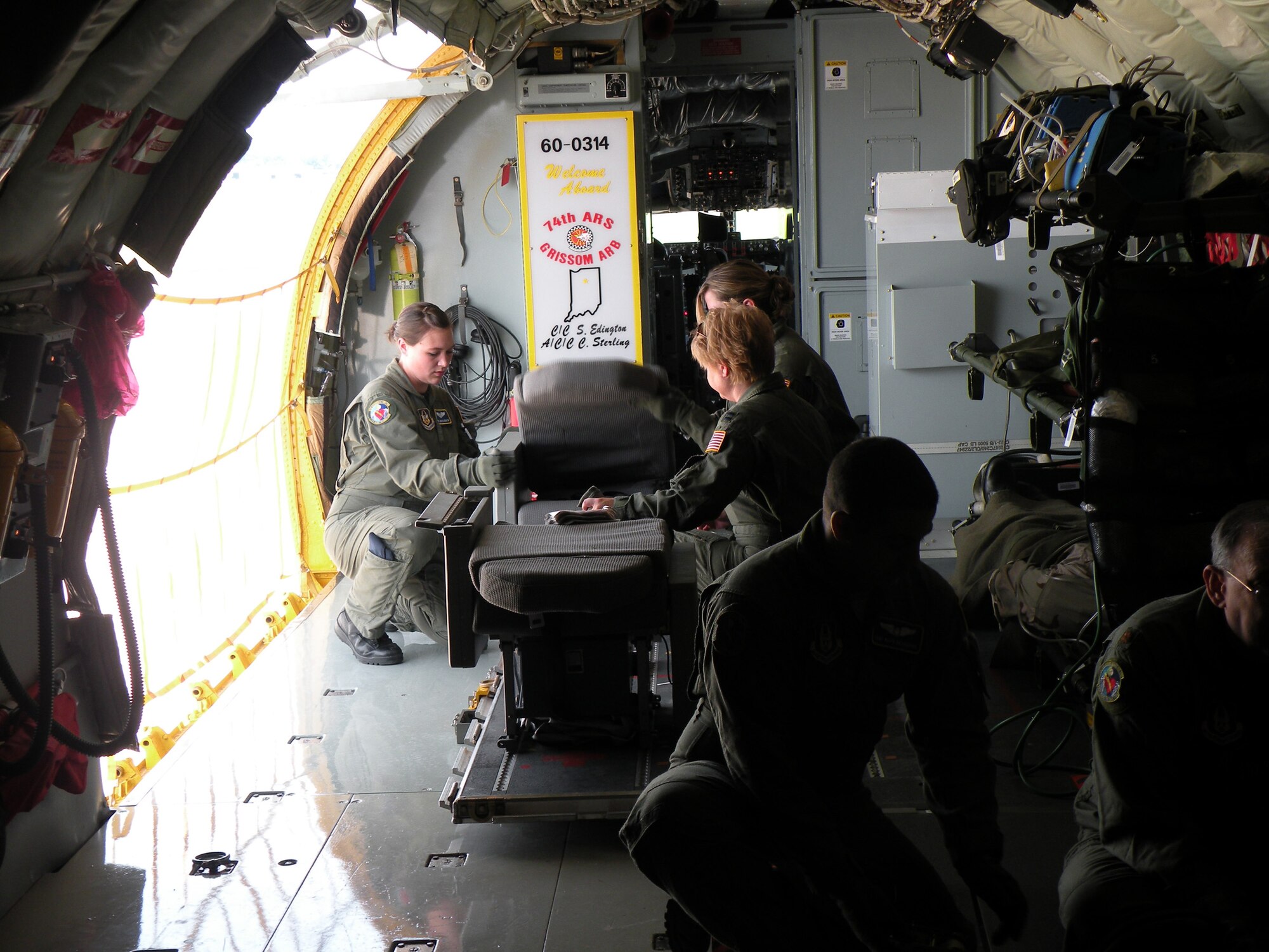 WRIGHT-PATTERSON AIR FORCE BASE, Ohio – Senior Airman Jennifer Edington, left, Capt. LaDonna Schreffler, middle, and Tech. Sgt. Sarah McKown, all from the 445th Aeromedical Evacuation Squadron, are working on a patient support pallet that was used for litter patients transported on a KC-135 Stratotanker.  Training during the 2-day Dissimilar Aircraft Refresher Training allowed AES participants to practice configuring each of the available aircraft through static training followed by two-hour flying training missions in the afternoon.  The flying missions involved running various emergency scenarios on simulated patients. (U. S. Air Force photo/2nd Lt. Katie Spellman)