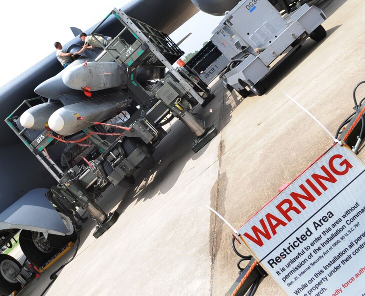 BARKSDALE Air Force Base, La. - Two members of the 2d Aircraft Maintenance Squadron finish loading a simulated weapon on a B-52H during the NSSAV July 30. (United States Air Force photo by Senior Airman Alexandra Longfellow) 