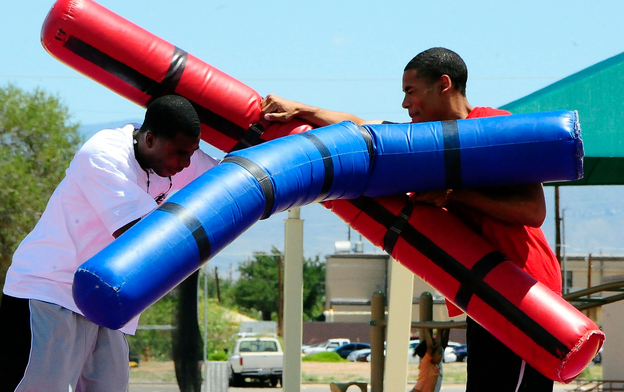 HOLLOMAN AIR FORCE BASE, N.M. -- Airman 1st Class Demetrius Jackson and Airman 1st Class Robert Collins, both Material Maintenance technicians from the 49th Logistics Readiness Squadron, joust at the 49th Mission Support Group's Extreme Challenge and picnic. (U.S. Air Force Photoby Tech Sgt. Chris Flahive)