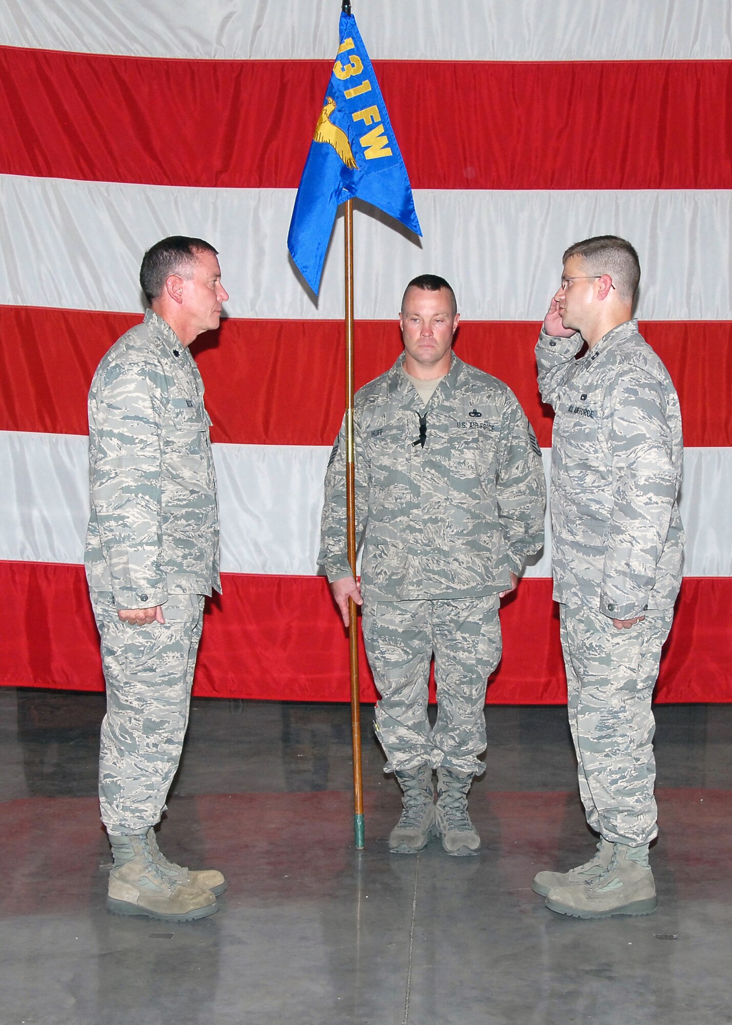 "Sir, I assume command!" Capt. Mark Risley, incoming 131st Maintenance Operations Flight commander, salutes Lt. Col. Mark Beck, 131st Maintenance Group commander, during the Assumption of Commands ceremony held at the Army National Guard Armory,  Whiteman Air Force Base, Mo., Aug 8.  (U.S. Air Force Photo by Master Sgt. Mary-Dale Amison)