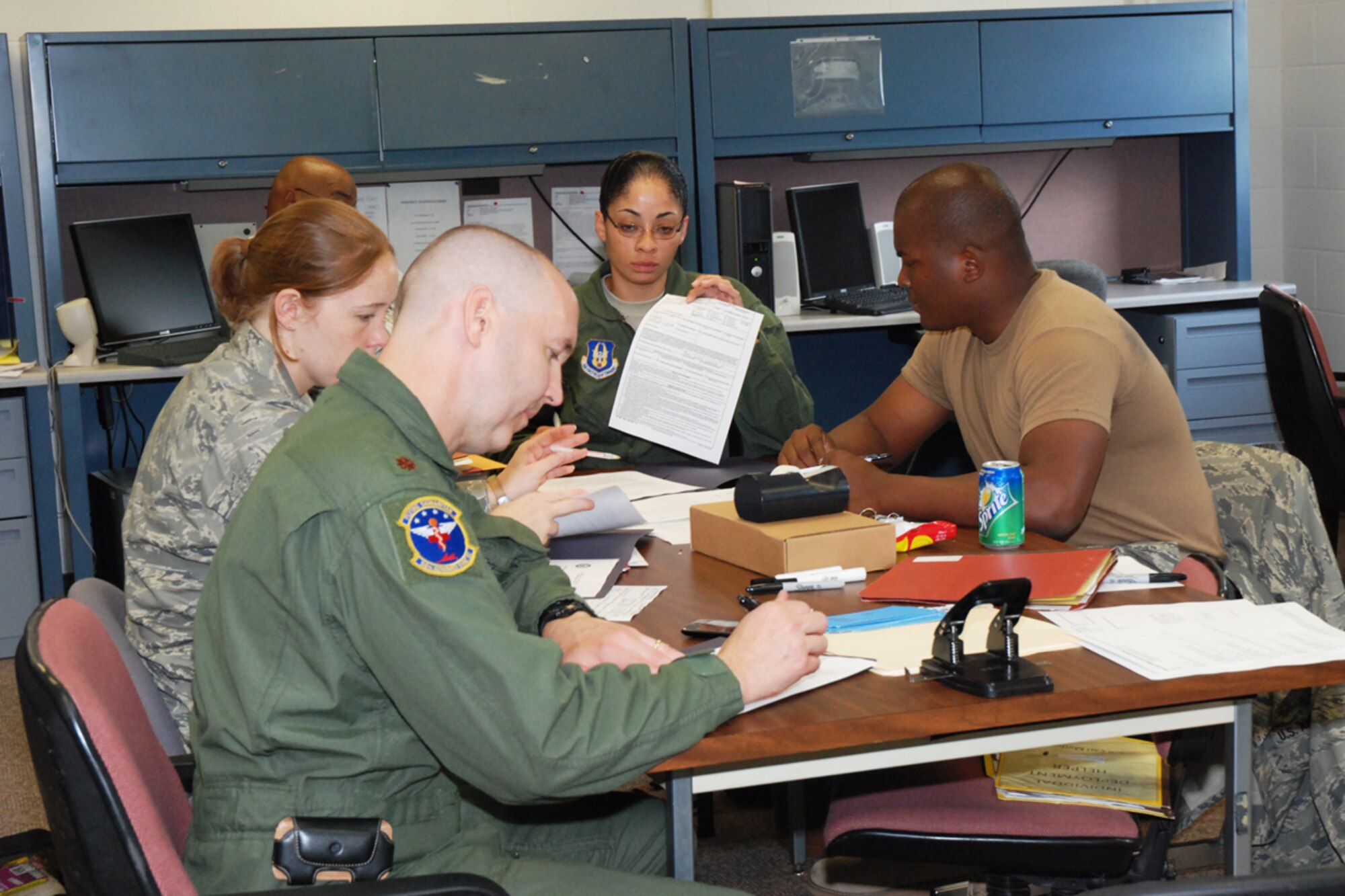 Airmen from the 94th Aeromedical Evacuation Squadron go through a checklist to ensure their needs are taken care of during an in-briefing Aug. 13 at their squadron. The Airmen recently returned from a four-month deployment to Ramstein Air Base, Germany, where they provided medical care to injured troops supporting the war on terror. (U.S. Air Force photo/Kennith Green)