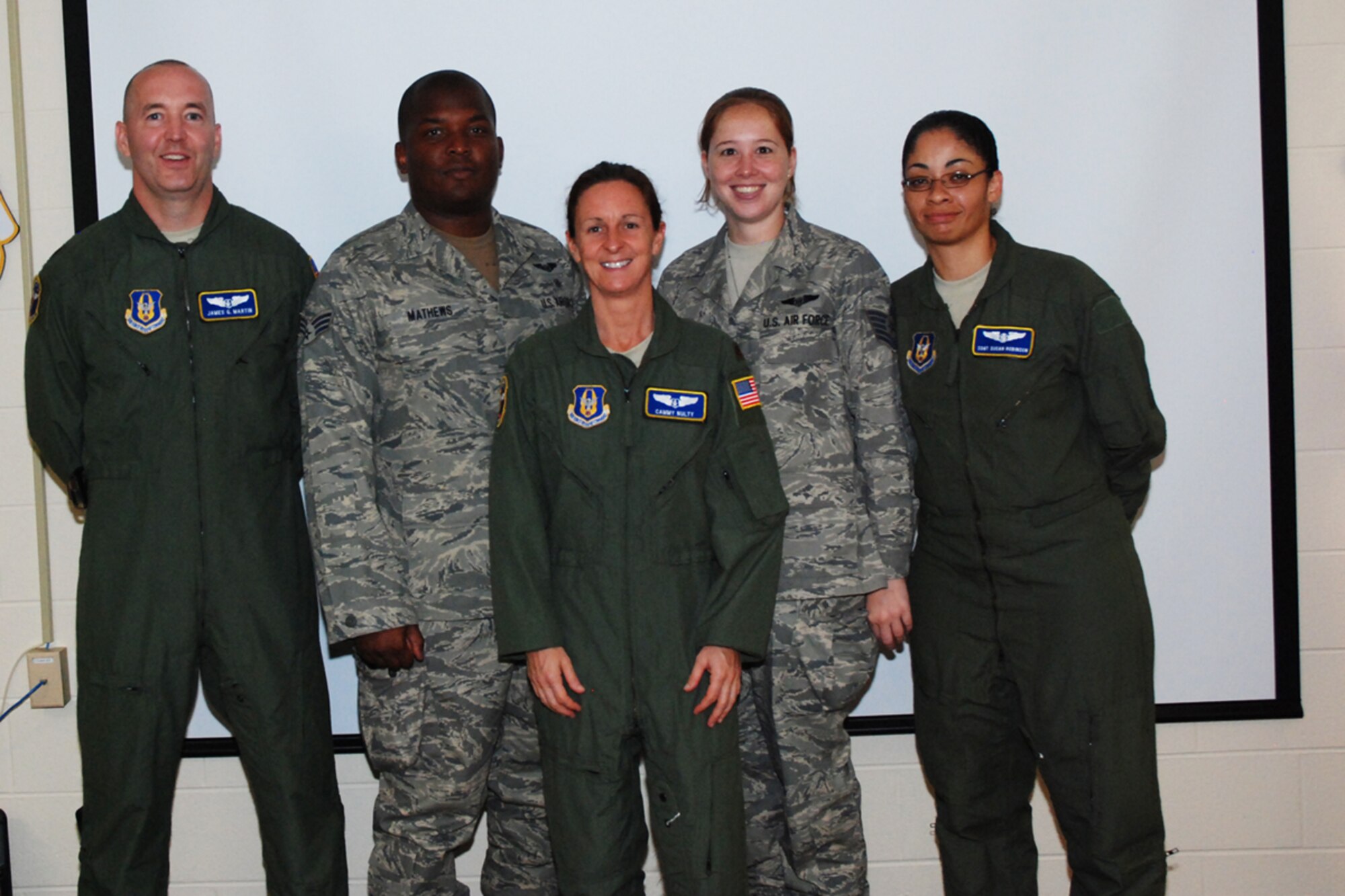 From left to right: Maj. James Martin, Senior Airman Carl Mathews, Maj. Camella 'Cammy' Nulty, Tech. Sgt. Deanne Kelley and Staff Sgt. Susan Robinson Airmen, all from the 94th Aeromedical Evacuation Squadron, participate in an in-briefing Aug. 13 at their squadron after returning from a four-month deployment to Ramstein Air Base, Germany. While the Airmen were deployed, they provided medical care to injured troops supporting the war on terror. (U.S. Air Force photo/Kennith Green)