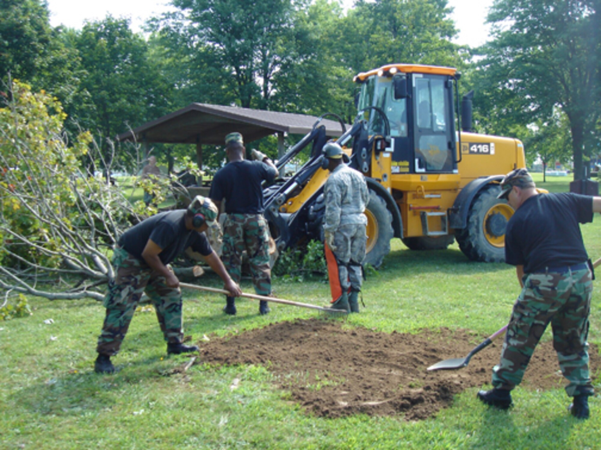 A 512th Civil Engineer Squadron team ensured the Eagles Nest picnic area was safe for the wing's picnic Aug. 1, following an overnight thunderstorm which uprooted a tree. (U.S. Air Force photo/Master Sgt. Veronica A. Aceveda)                                            