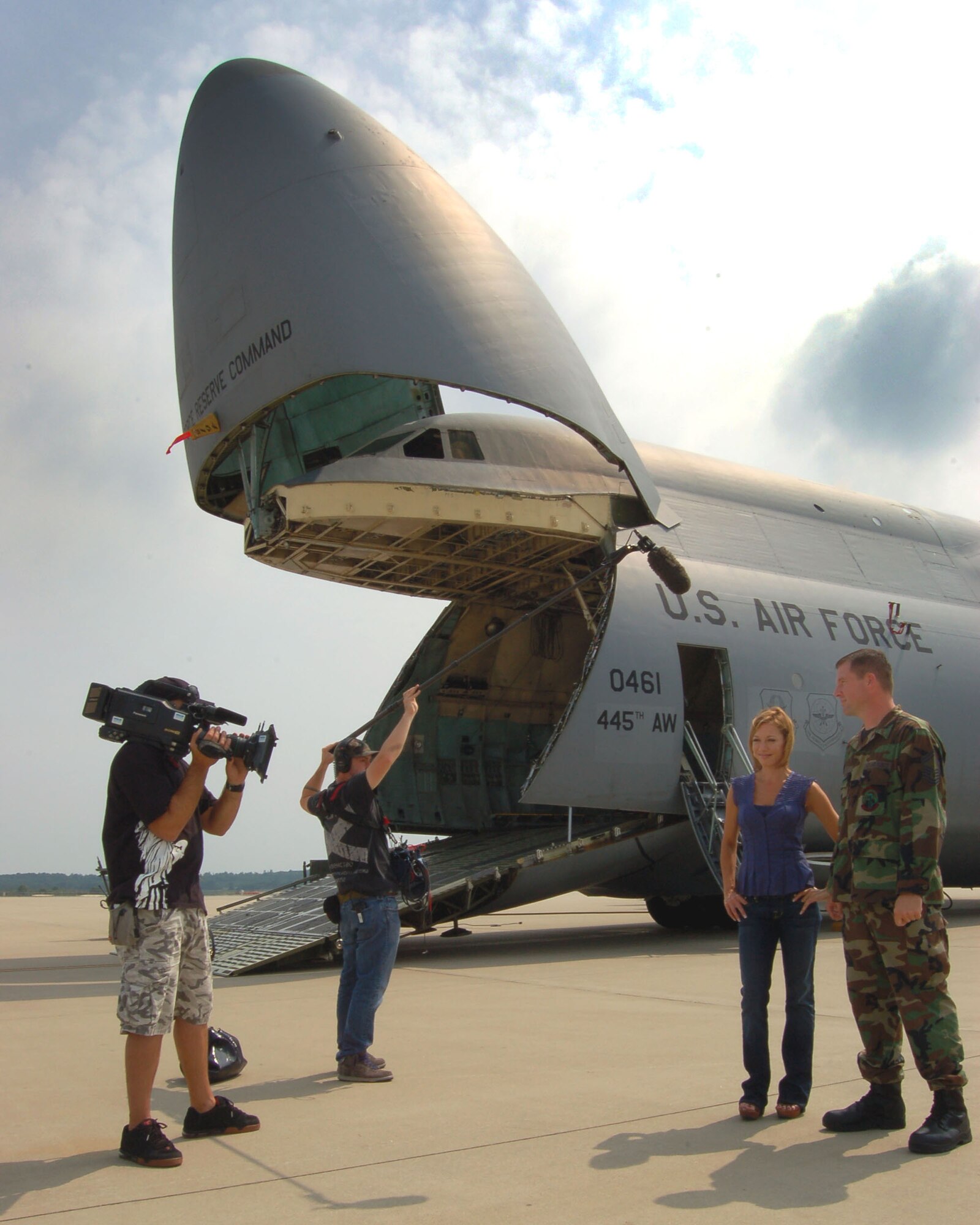 WRIGHT-PATTERSON AIR FORCE BASE, Ohio – A film crew tapes Senior Master Sgt. Michael West, 445th Aircraft Maintenance Squadron, for a scene with Ms. Lisa Joyner, host of ABC’s new show, “Find My Family,” in front of a C-5 Galaxy at Wright-Patterson Air Force Base, Ohio, Aug. 8.  The show is a documentary series featuring reunions of those who have been separated and explores the issues involved when people separate and the lengths some go to reunite, find answers, and discover lost family.  The scene taped at the 445th Airlift Wing featured a lieutenant from McConnell Air Force Base, Kan., who was reunited with his long-lost sister in Ohio.  The film crew wanted to use an Air Force base near the sister’s residence.  The show will air this fall.  (U. S. Air Force photo/Maj. Jose A. Cardenas)