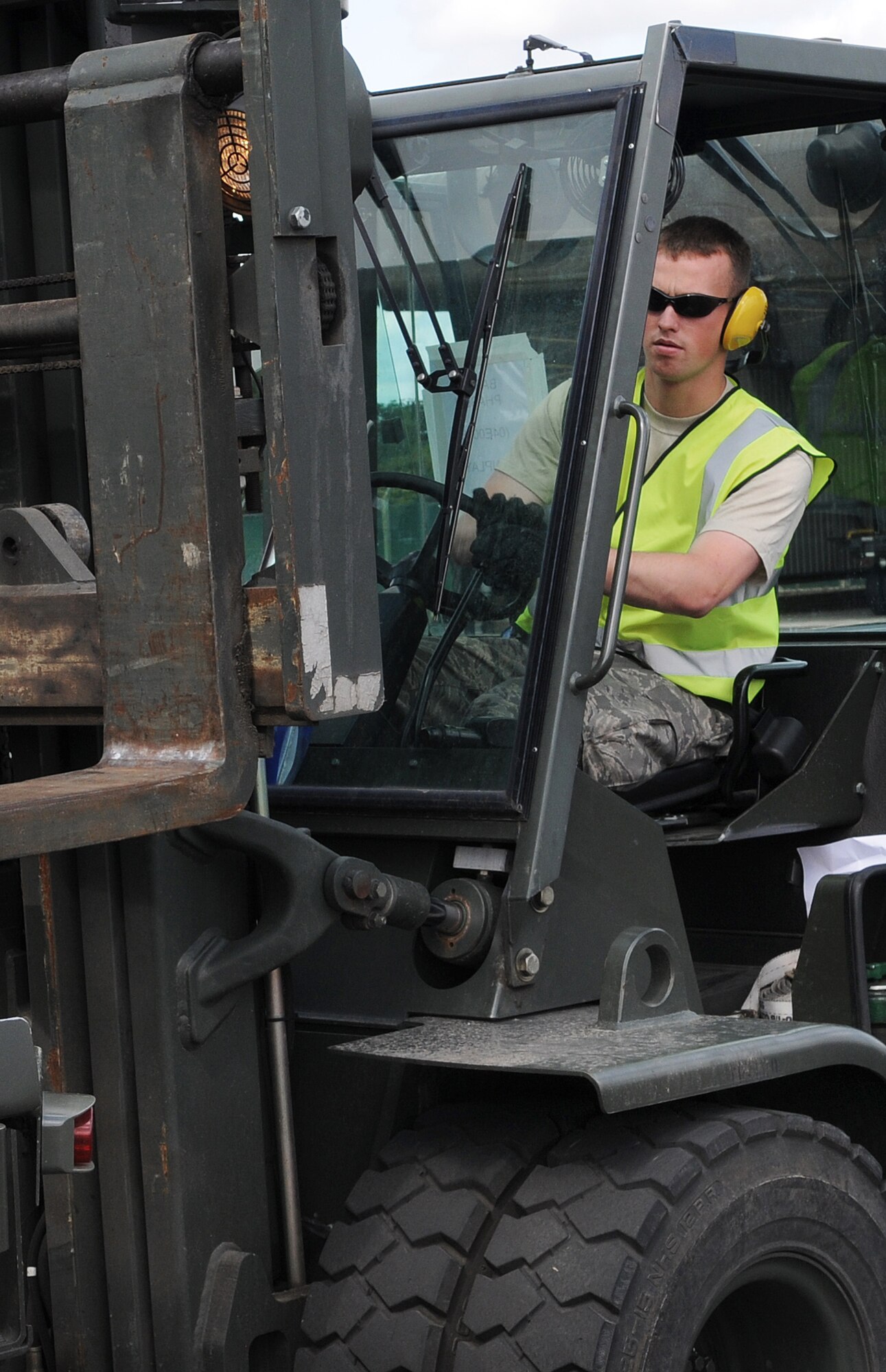RAF MILDENHALL, England -- Senior Airman Timothy Moore, 100th Logistics Readiness Squadron, drives a 5-ton forklift while moving pallets in the cargo yard Aug. 13. Airman Moore, normally a vehicle maintenance technician, was augmented to work in the yard and prepare cargo shipments for about 11 chalks.  (U.S. Air Force photo by Senior Airman Thomas Trower)