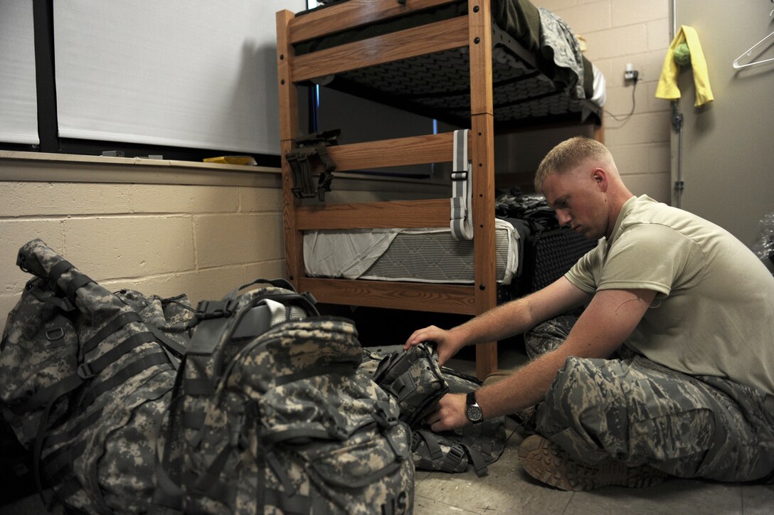 Senior Airman Chris Hayes inspects his equipment during Combat Skills Training July 26 at Fort Dix, N.J. CST is a month-long Army training program that prepares Airmen for Joint Expeditionary Tasking combat roles augmenting the U.S. Army. Airman Hayes is a traffic management journeyman assigned to the 60th Aerial Port Squadron at Travis Air Force Base, Calif. (U.S. Air Force photo/Senior Airman Larry E. Reid Jr.) 