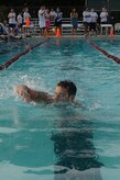 Senior Airman Joseph Jurotich participates in a six-man swimming relay race during the Commander's Challenge at the base pool Aug. 7. Airman Jurotich had to swim a lap before his teammate could enter the water. Airman Jurotich is a member of the 437th Civil Engineer Squadron.