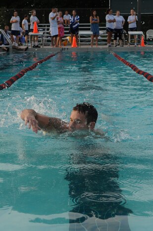 Senior Airman Joseph Jurotich participates in a six-man swimming relay race during the Commander's Challenge at the base pool Aug. 7. Airman Jurotich had to swim a lap before his teammate could enter the water. Airman Jurotich is a member of the 437th Civil Engineer Squadron.