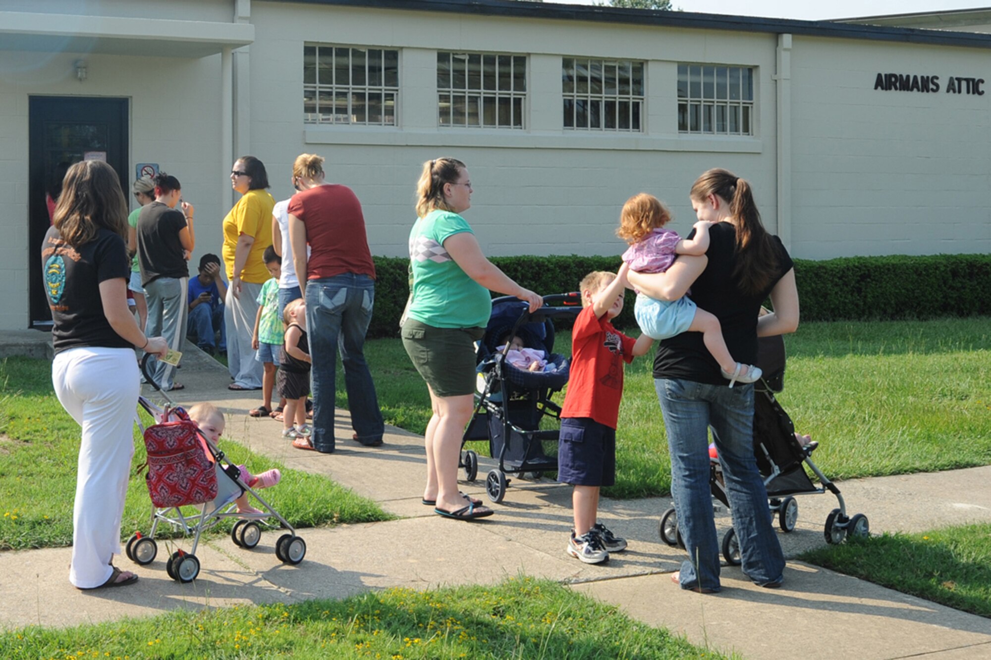 Military dependants wait for the Seymour Johnson Airman's Attic to open, Aug. 5, 2009. About 100 military members and dependants visit the Airman's Attic weekly. The Airman's Attic was designed to provide assistance for young Airmen who cannot afford all the things they need to set up a household. (U.S. Air Force photo by Airman 1st Class Whitney Lambert)