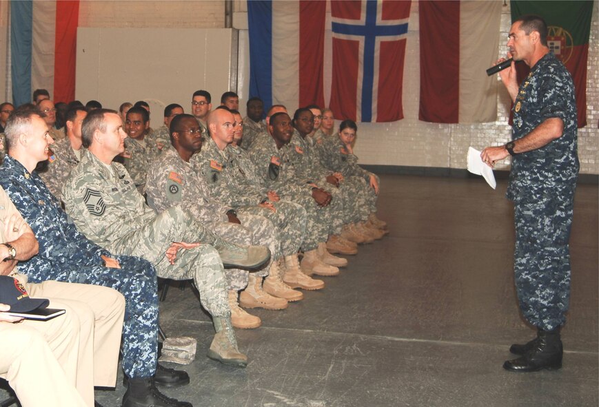 Fleet Master Chief Roy M. Maddocks, Jr speaks to enlisted members of units at Royal Air Force Molesworth during an all hands on August 12th, as JAC SEL Master Chief John C. Frakes and Chief Master Sgt. Allyn W. Webb, SEL for the EUCOM Director of Intelligence (at far left) observe.  The EUCOM SEL visited to assess QOL issues, professional development opportunities, and to see collaboration with partner nations.  (U.S. Air Force photo by Staff Sgt. Rachel A. Goff)    