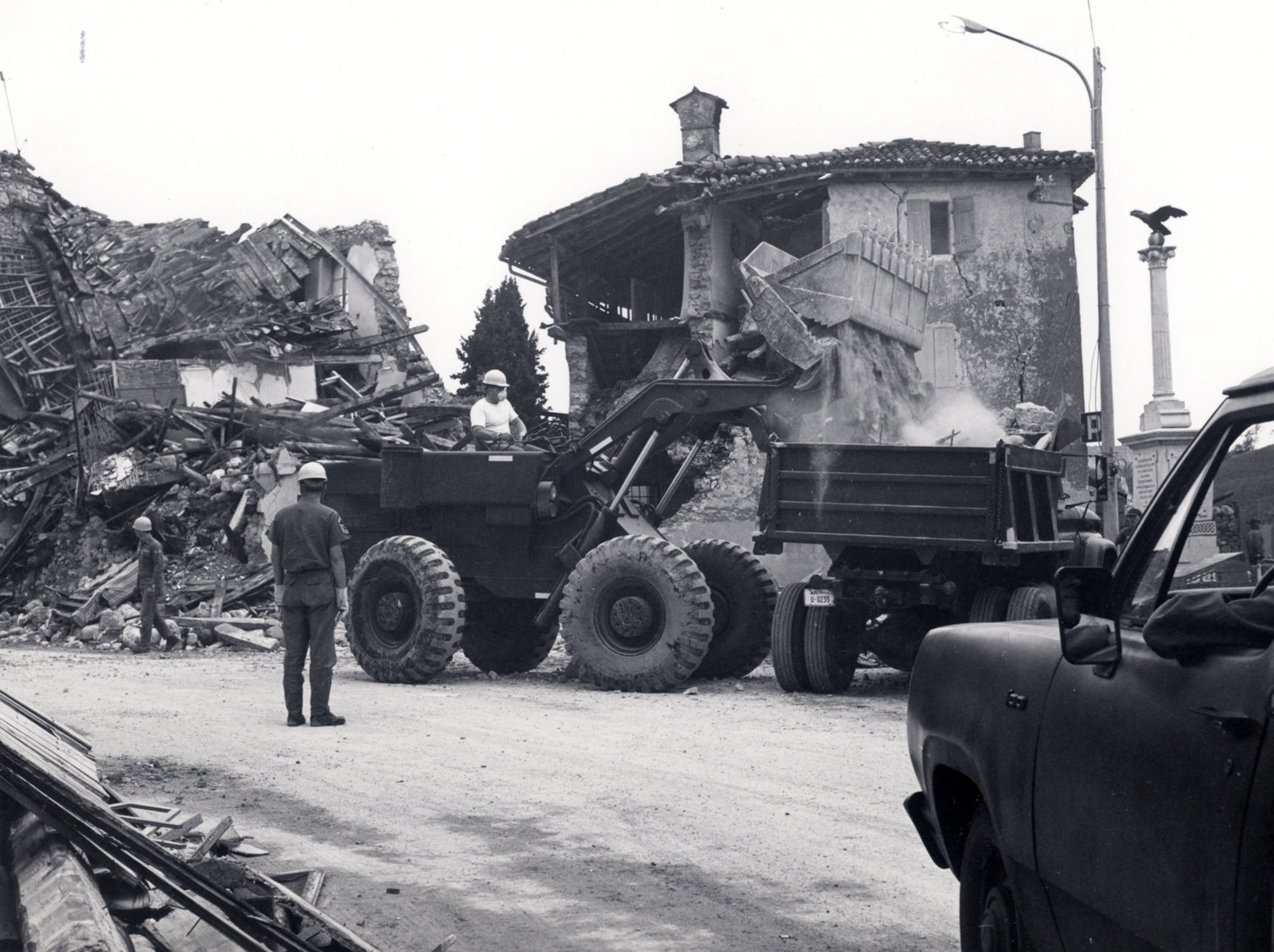 Italians and Airmen assigned to the former 40th Tactical Group at Aviano Air Base, Italy, worked together to clear roadways of debris to enable supply vehicles to transport relief materials to the May 6, 1976, earthquake victims.  The town of Forgaria nel Friuli, a community of about 3,000 people, had 70 casulties and almost total devastation of its homes.  Airmen from the 40th TG were among the first to provide support to the region.  (U.S. Air Force photo) 